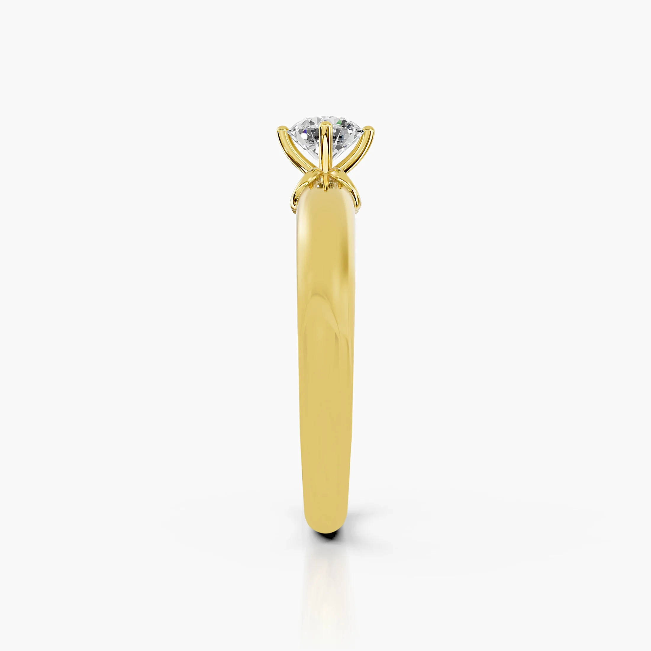 Round diamond solitaire ring with a scrollwork gallery on a polished gold band.