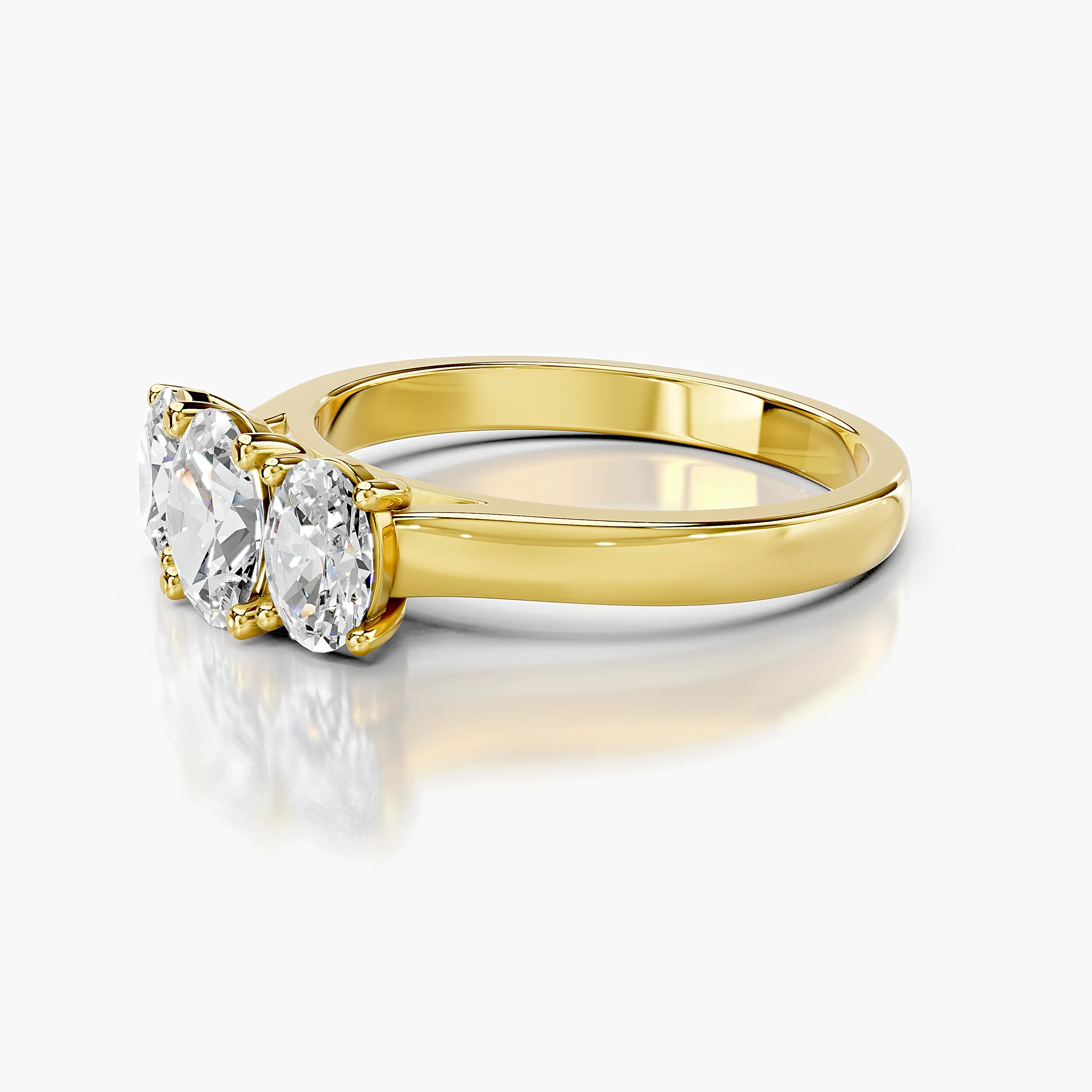Three-stone engagement ring featuring a center oval diamond flanked by two matching oval diamonds.