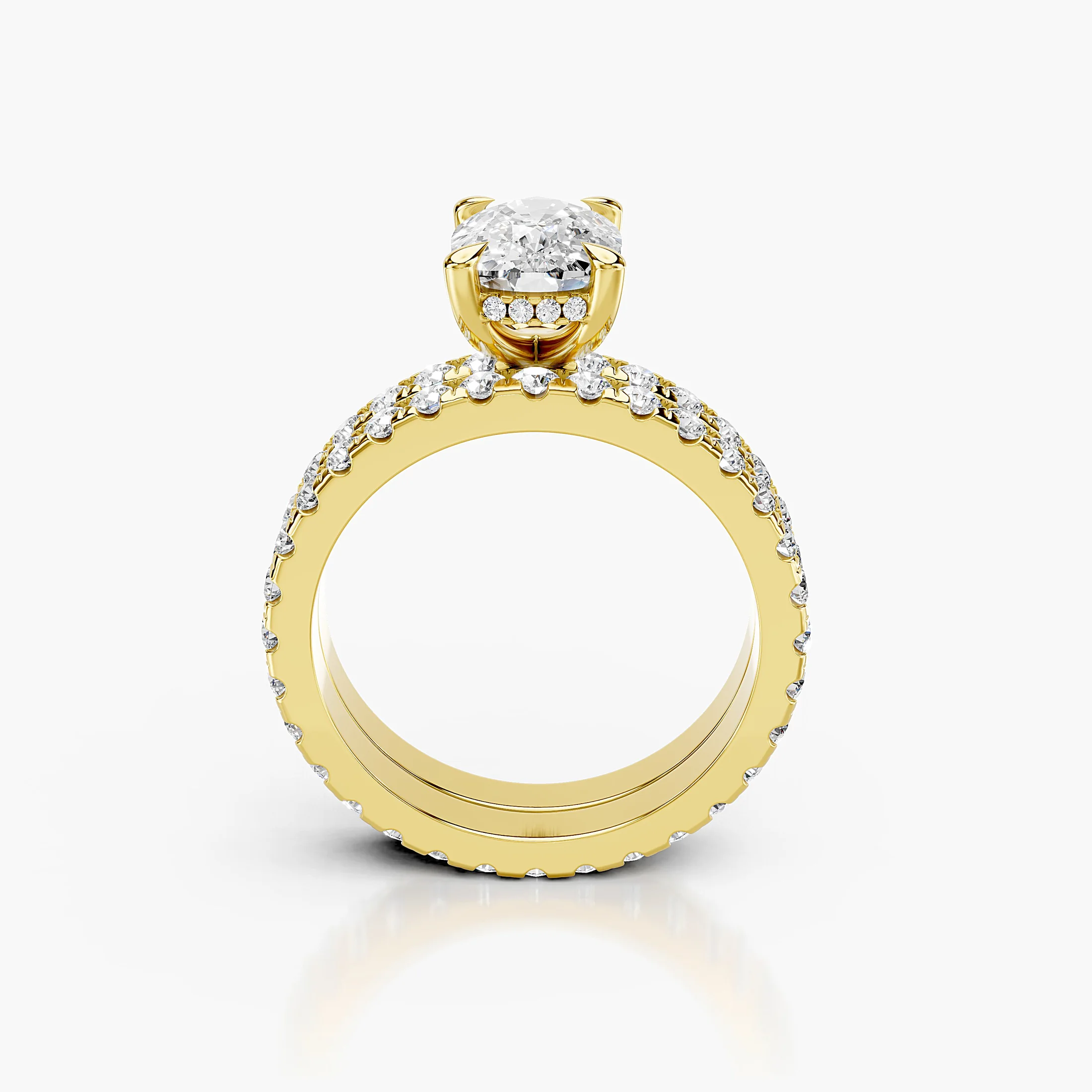 Cushion-shaped engagement ring with hidden halo, diamond-accented shoulders, and straight coordinating wedding band