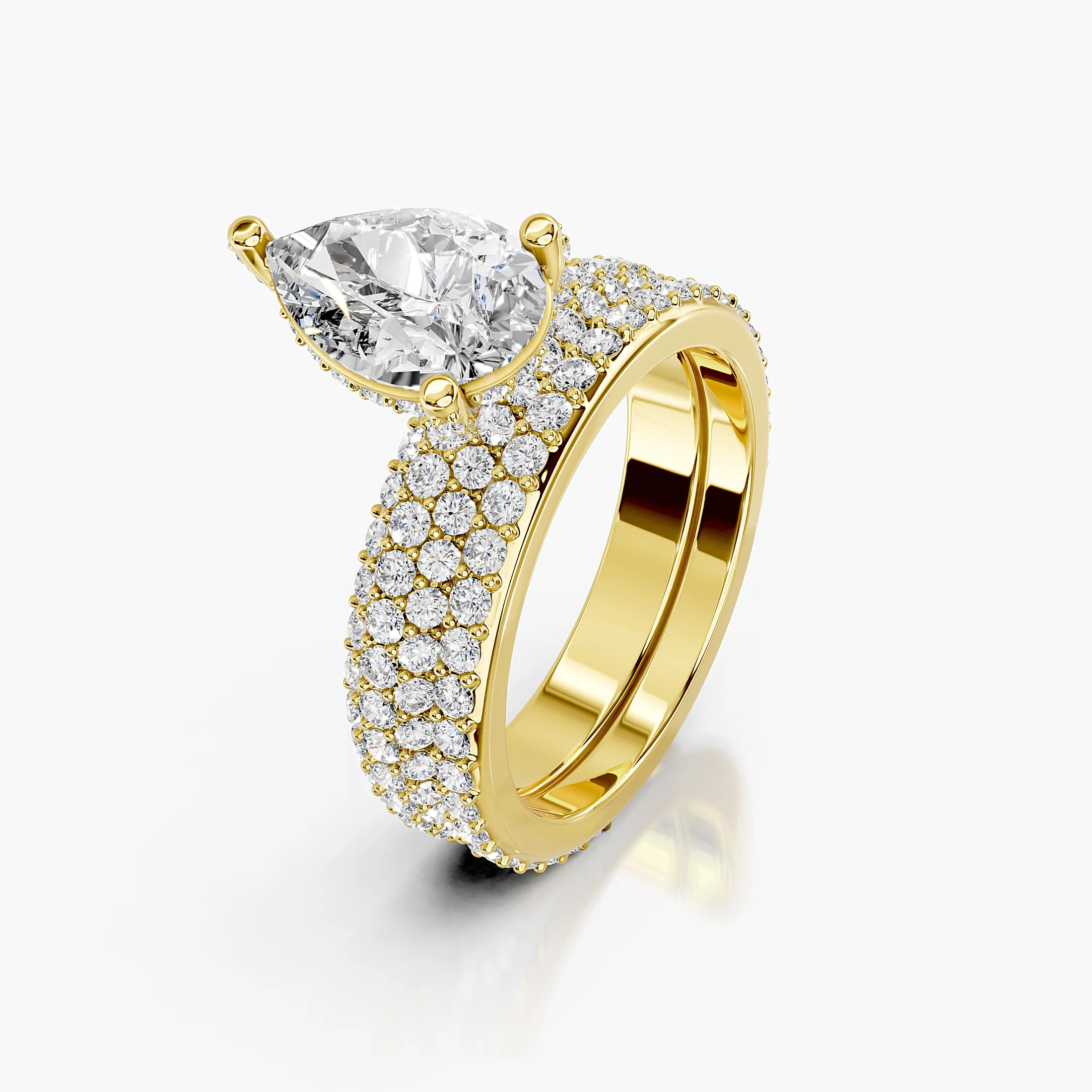 Pear diamond pavé bridal set with a prong-set center and layered curved diamond bands