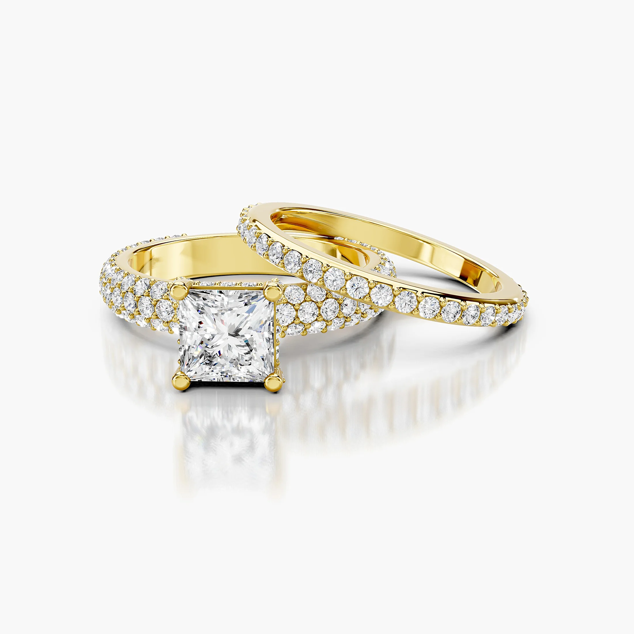 Princess diamond pavé bridal set with a four-prong center and coordinating straight diamond band