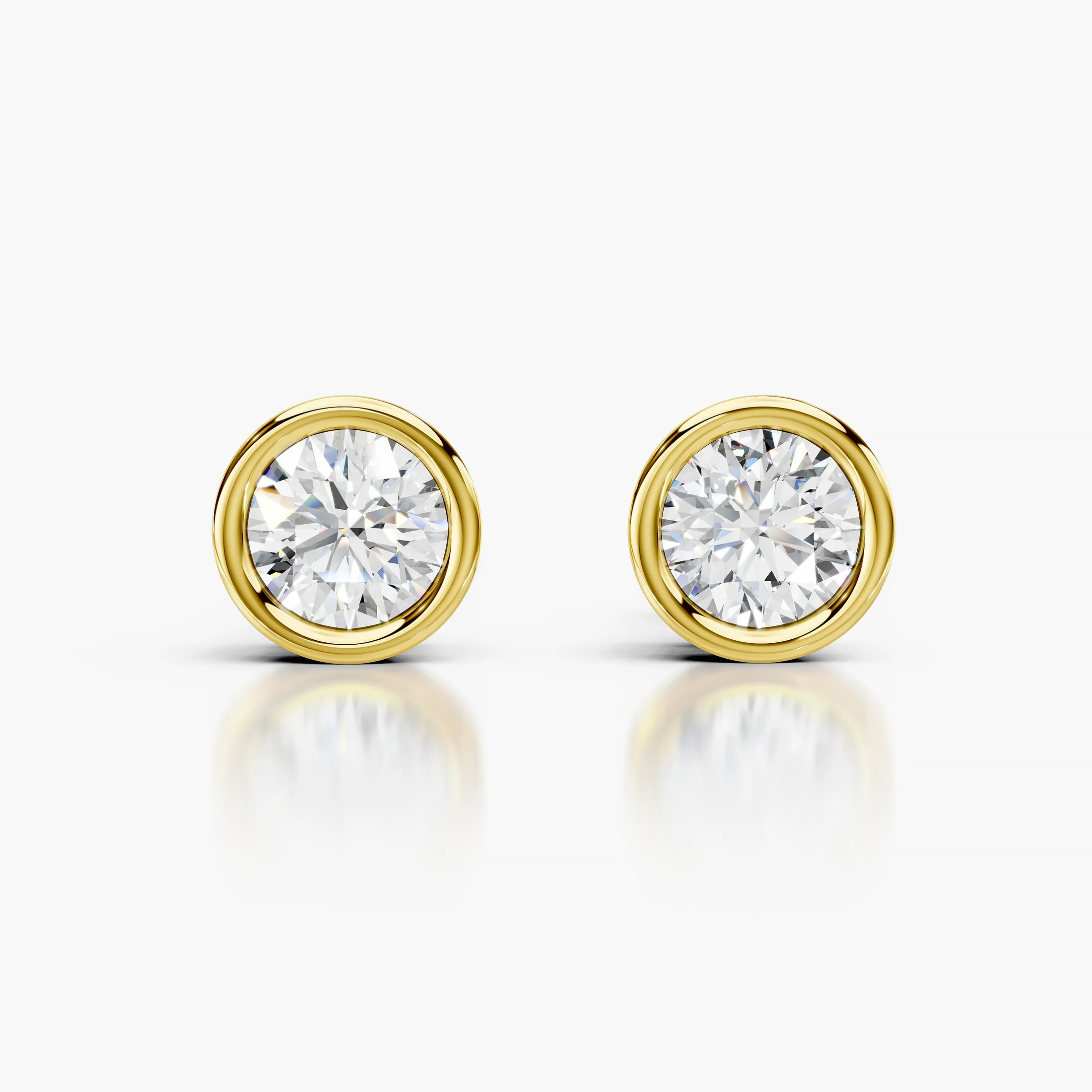 Round diamond solitaire stud earrings with smooth bezel settings