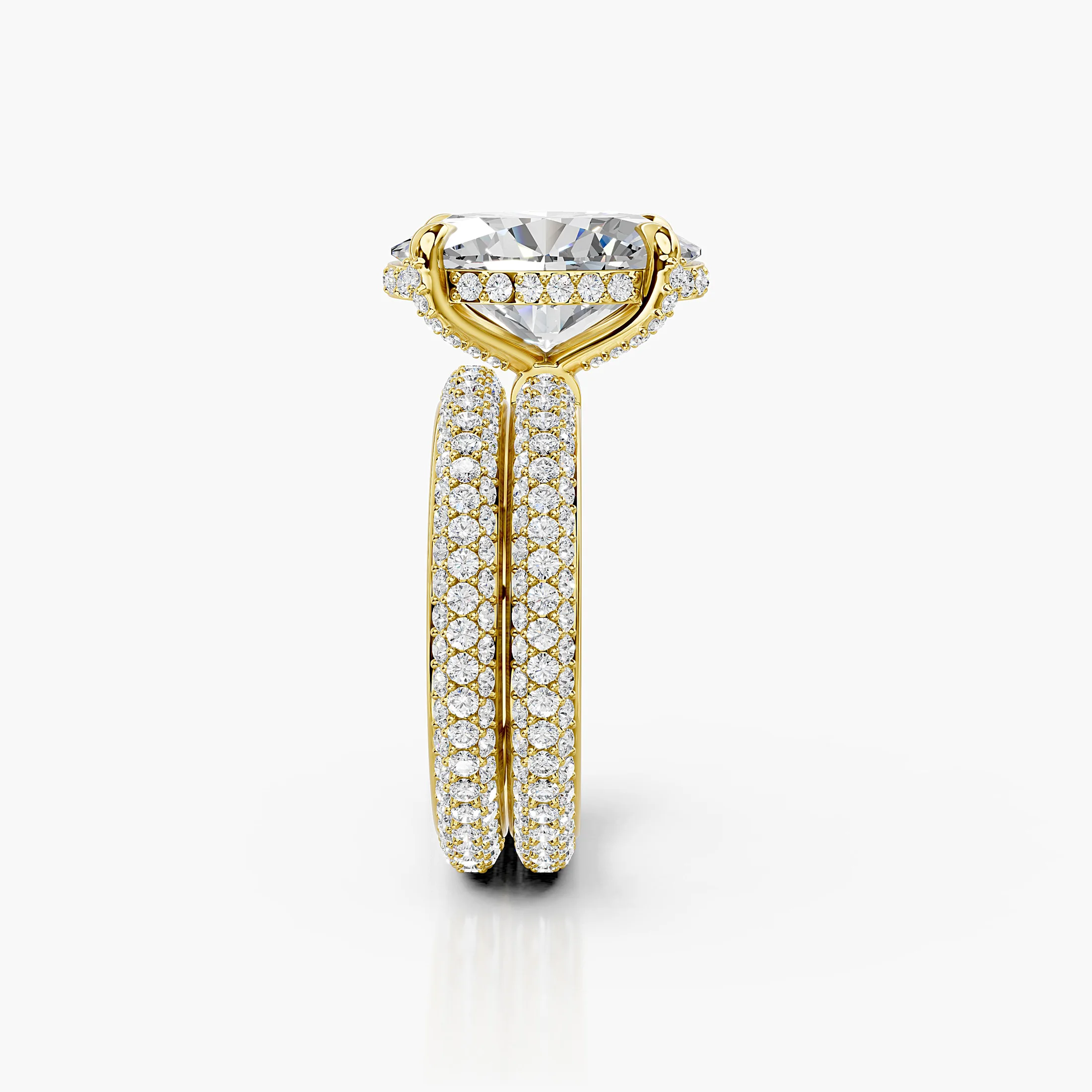 Two-piece bridal set featuring an oval-cut center stone in a pavé-set diamond band.