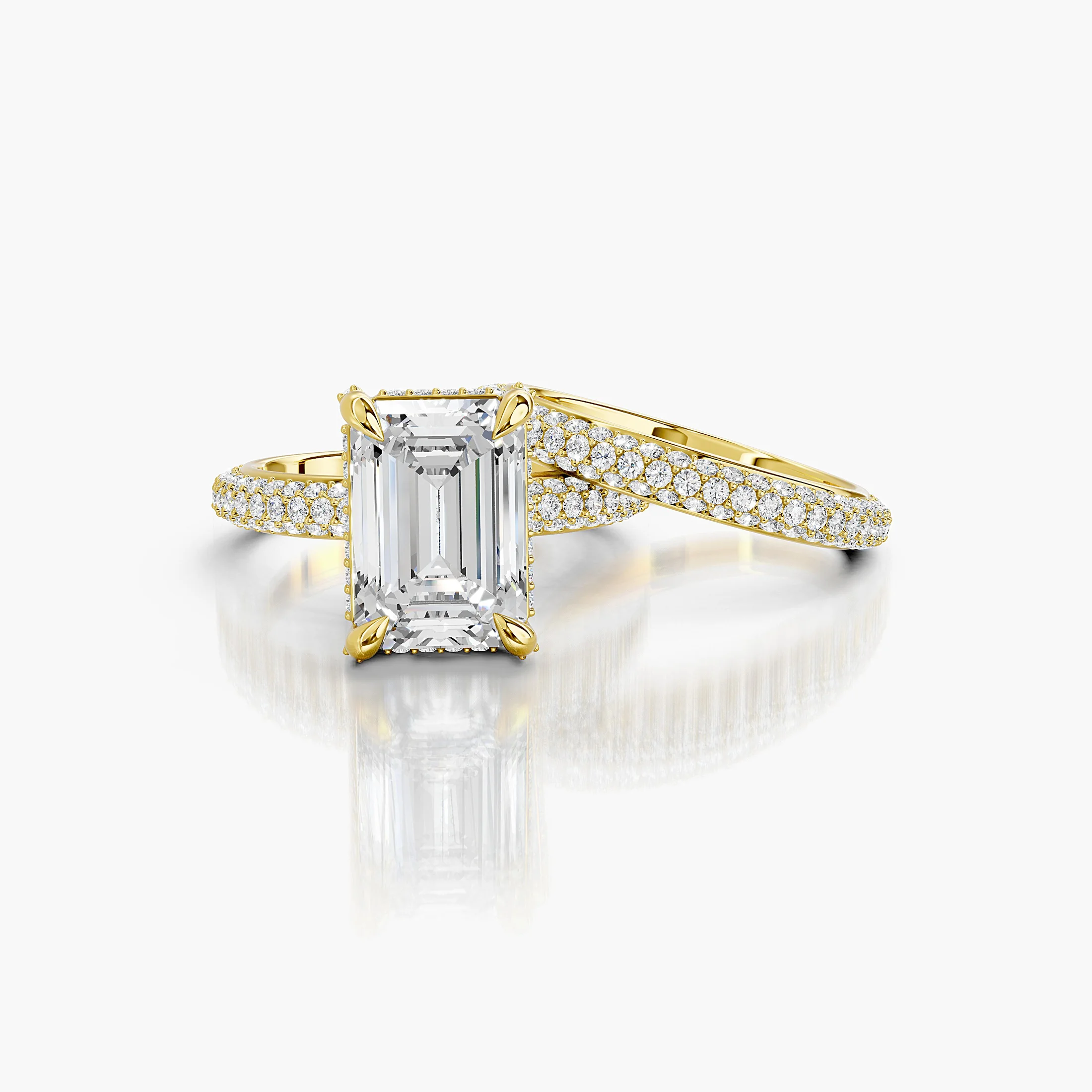 Two-piece bridal set featuring an emerald-cut center stone in a pavé-set diamond band.
