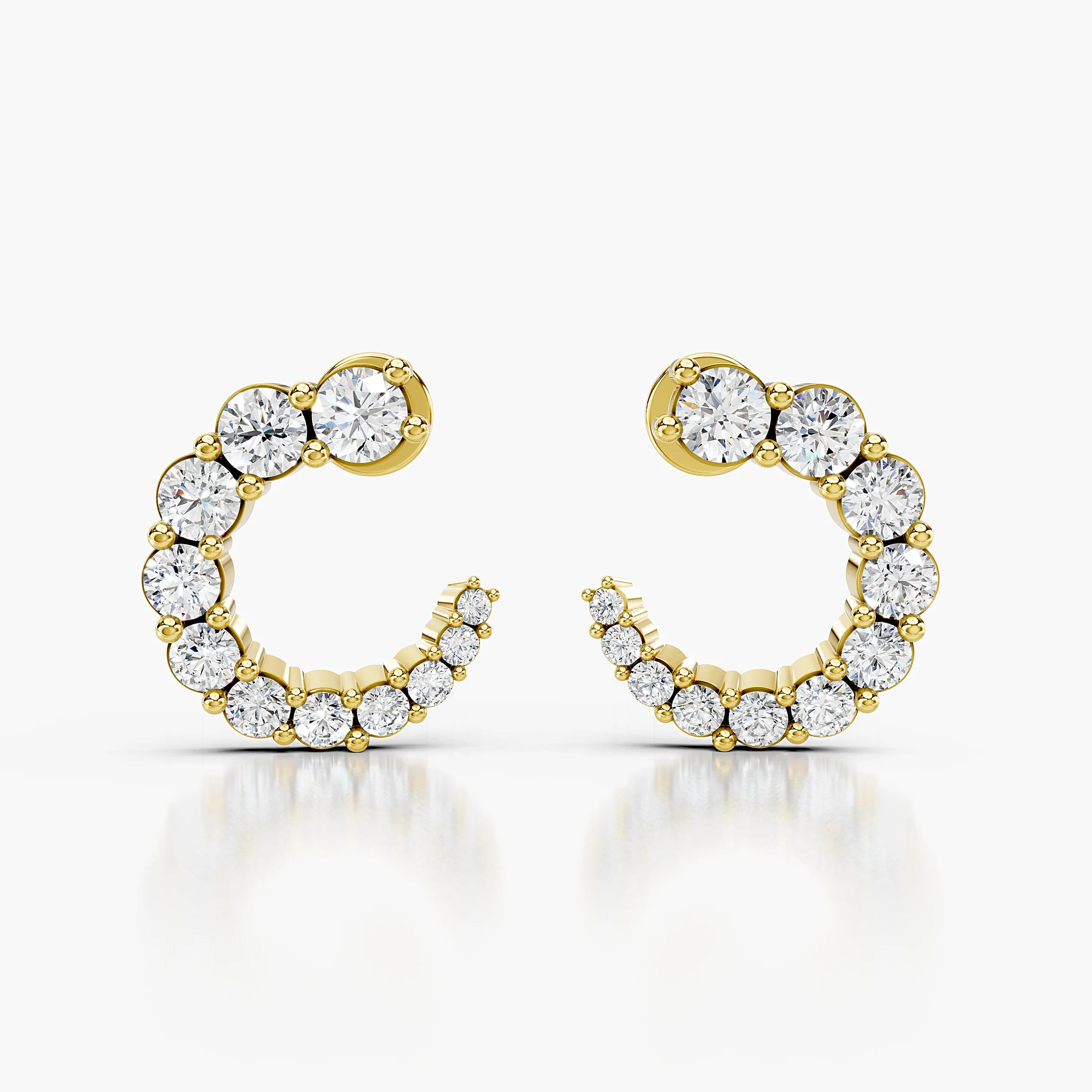 Pair of open C-shaped earrings with graduated round diamonds in prong settings