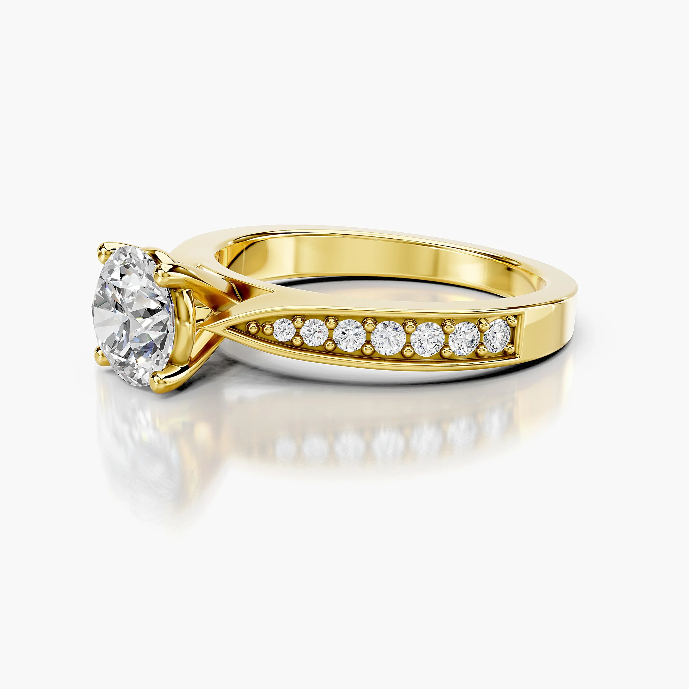 Round four-prong engagement ring with sculpted split shoulders and graduated side stones framed by polished rails.