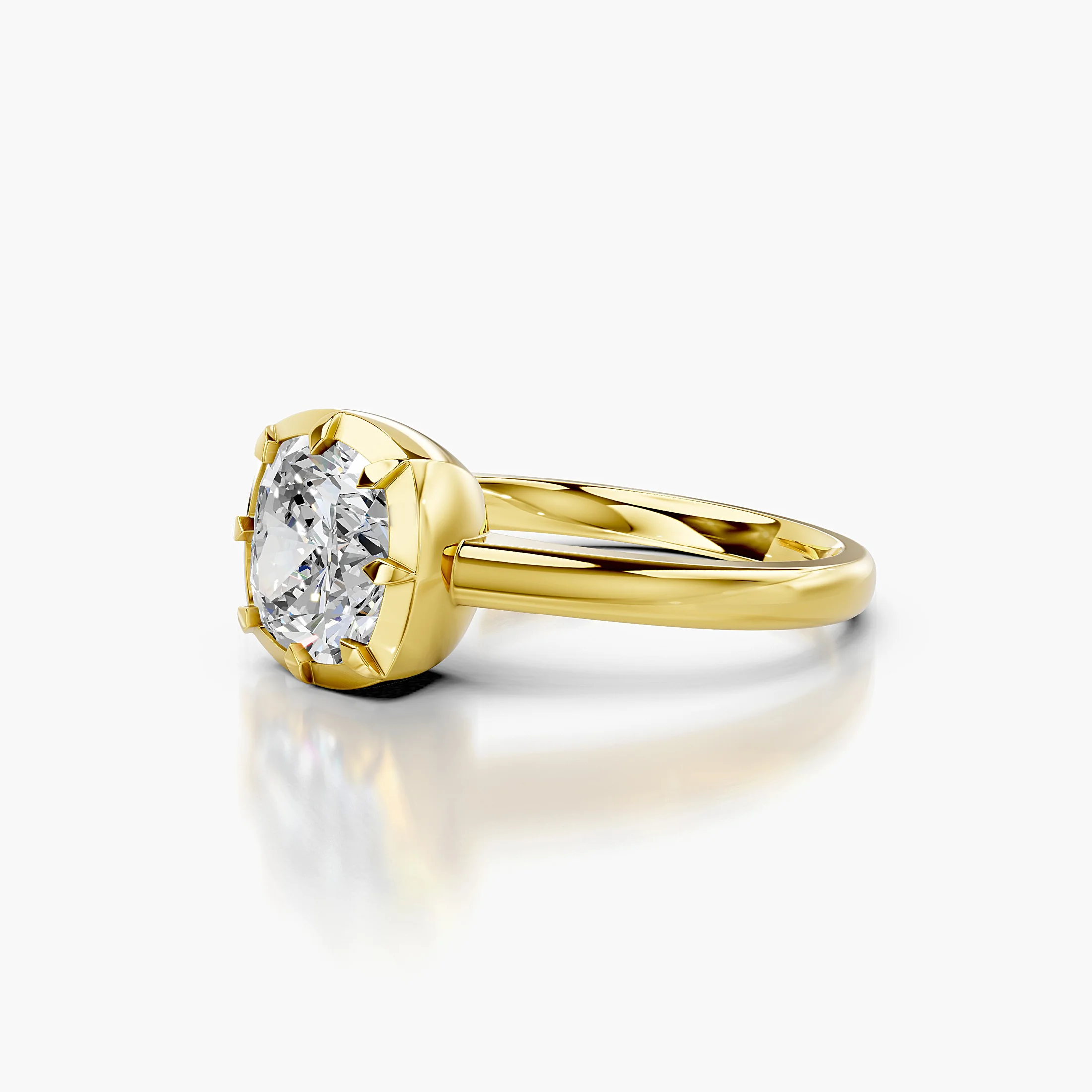 Cushion-cut diamond solitaire ring set in a notched bezel on a polished gold band.