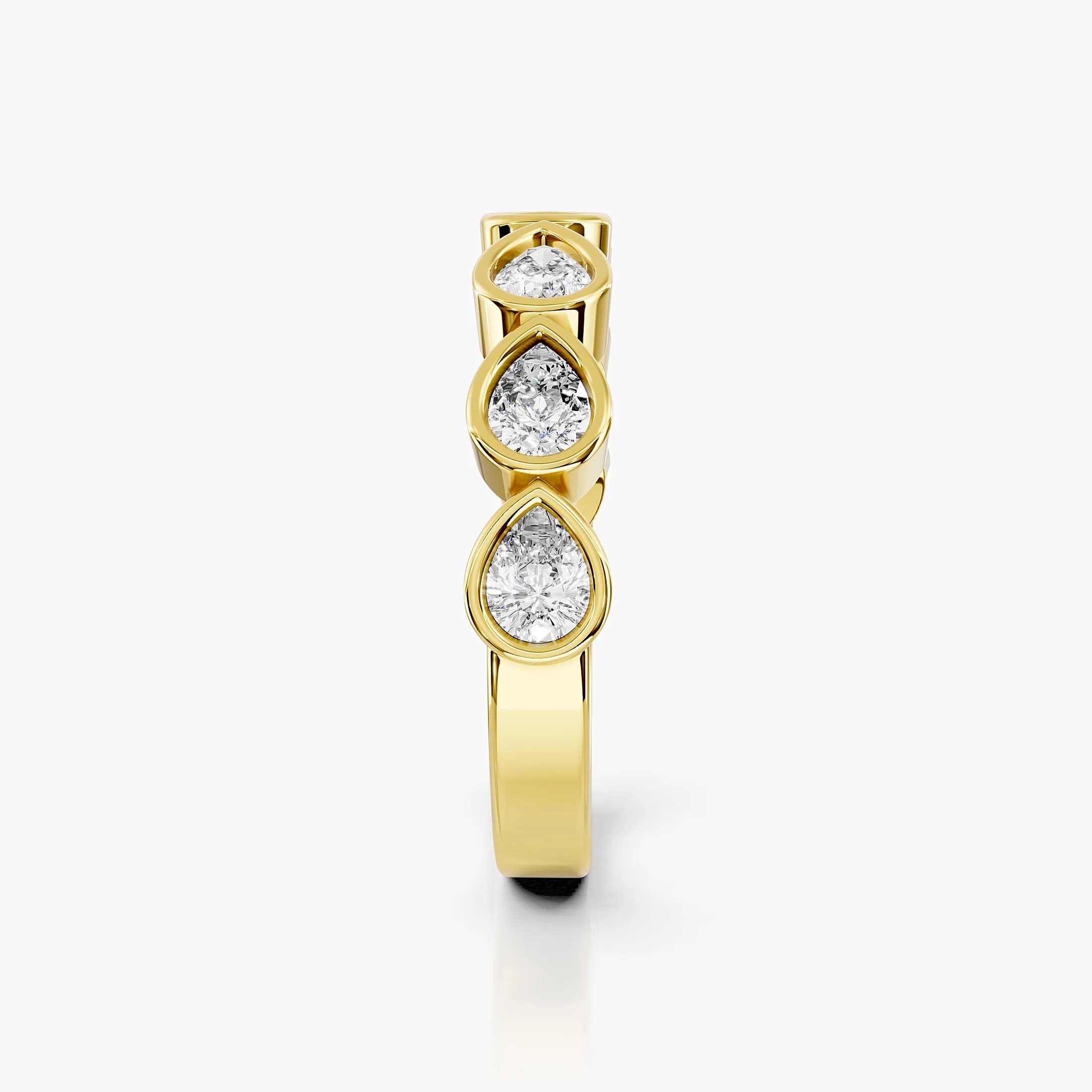 Wedding band featuring bezel-set pear-shaped diamonds arranged across a polished gold band.