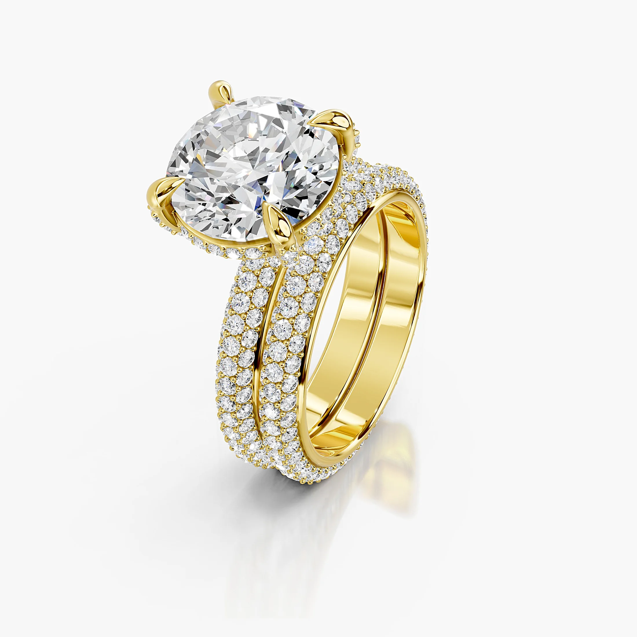 Elaris two-piece bridal ring set with a round center, raised four-prong hidden-halo setting, multi-row pavé shank, and straight coordinating band.