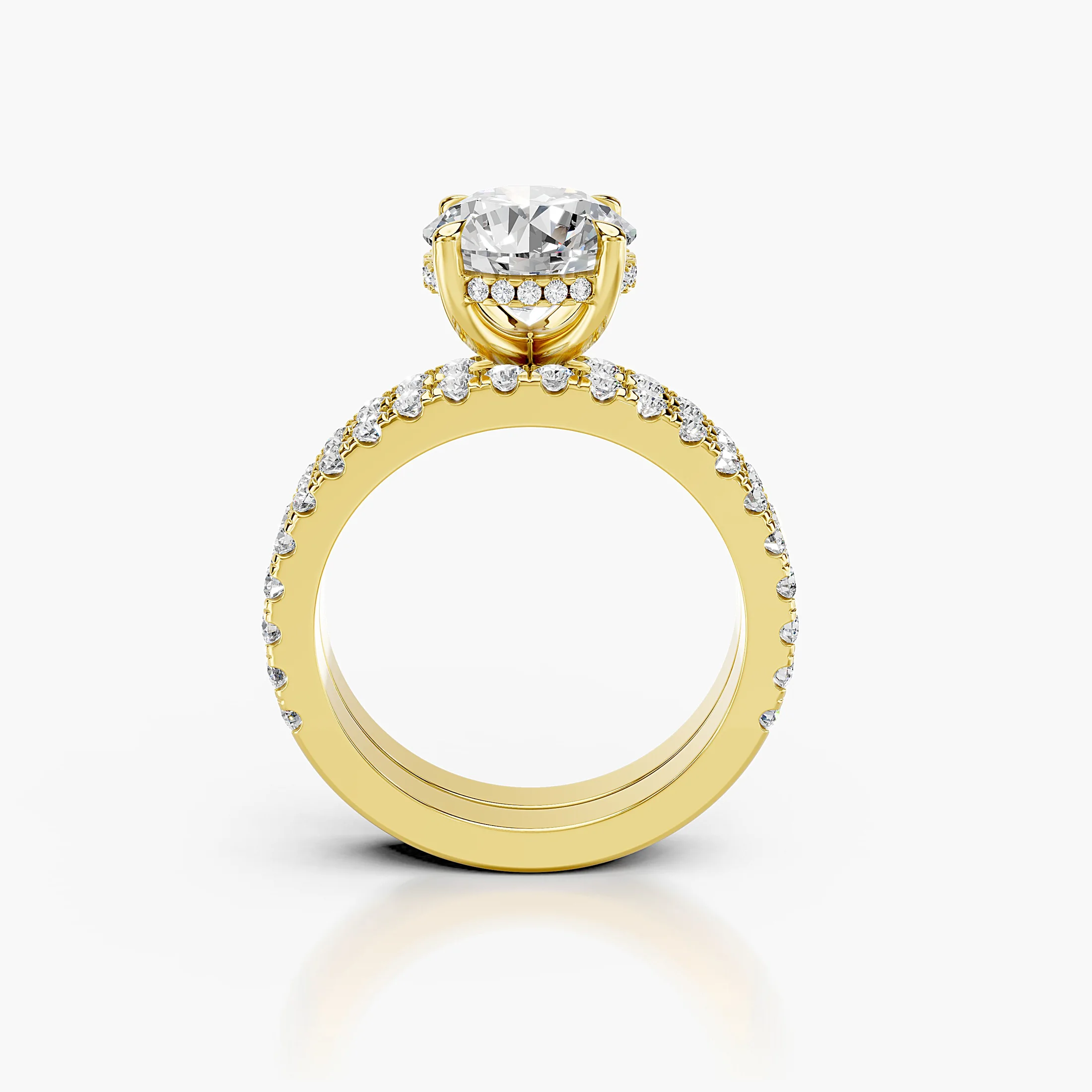 Round hidden halo side-stone engagement ring with a coordinating straight diamond band shown as a two-piece bridal set