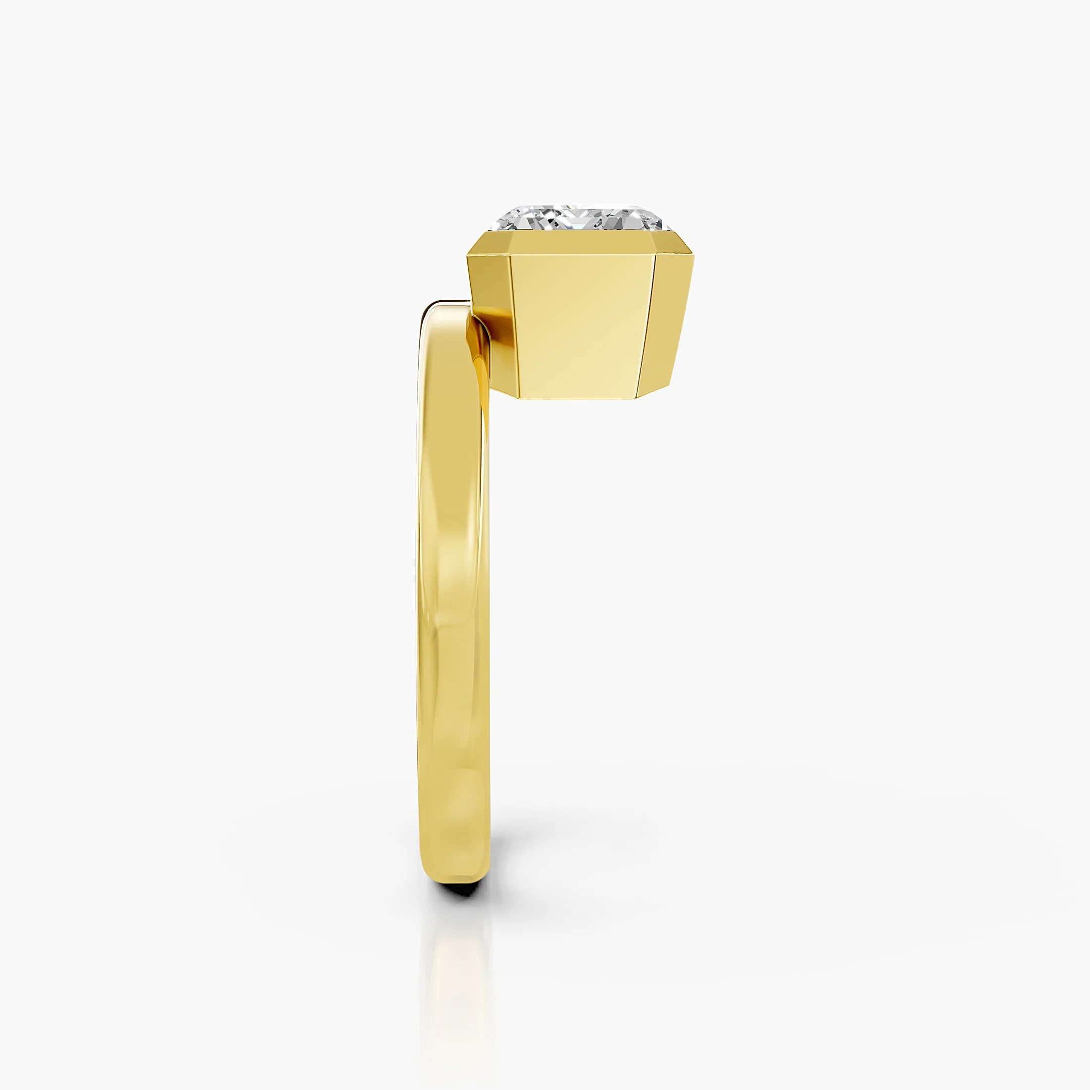 Emerald-cut diamond solitaire ring set in a bold bezel on a wide polished band.