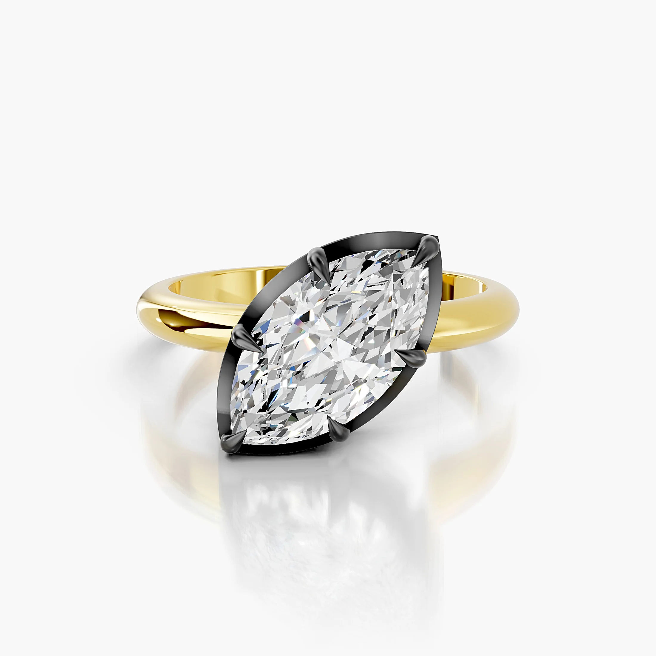 Marquise-cut diamond solitaire ring set in dark contrast prongs on a polished gold band.