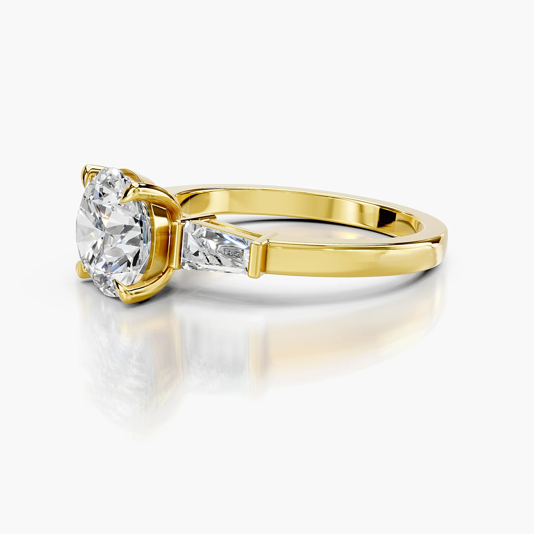 Three-stone engagement ring featuring a round center diamond flanked by tapered baguette diamonds.