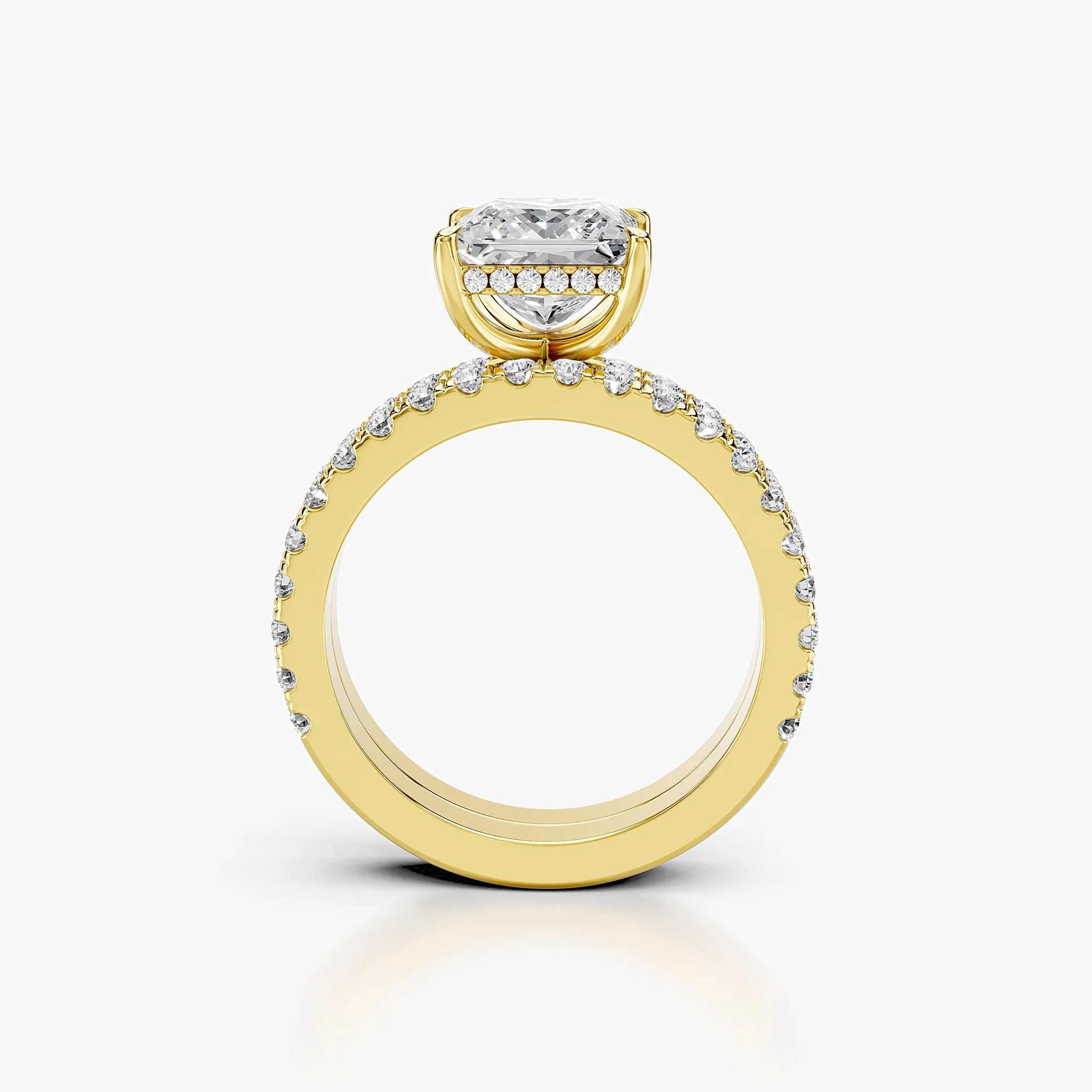 Princess-cut hidden halo side-stone engagement ring with a coordinating straight diamond band shown as a two-piece bridal set
