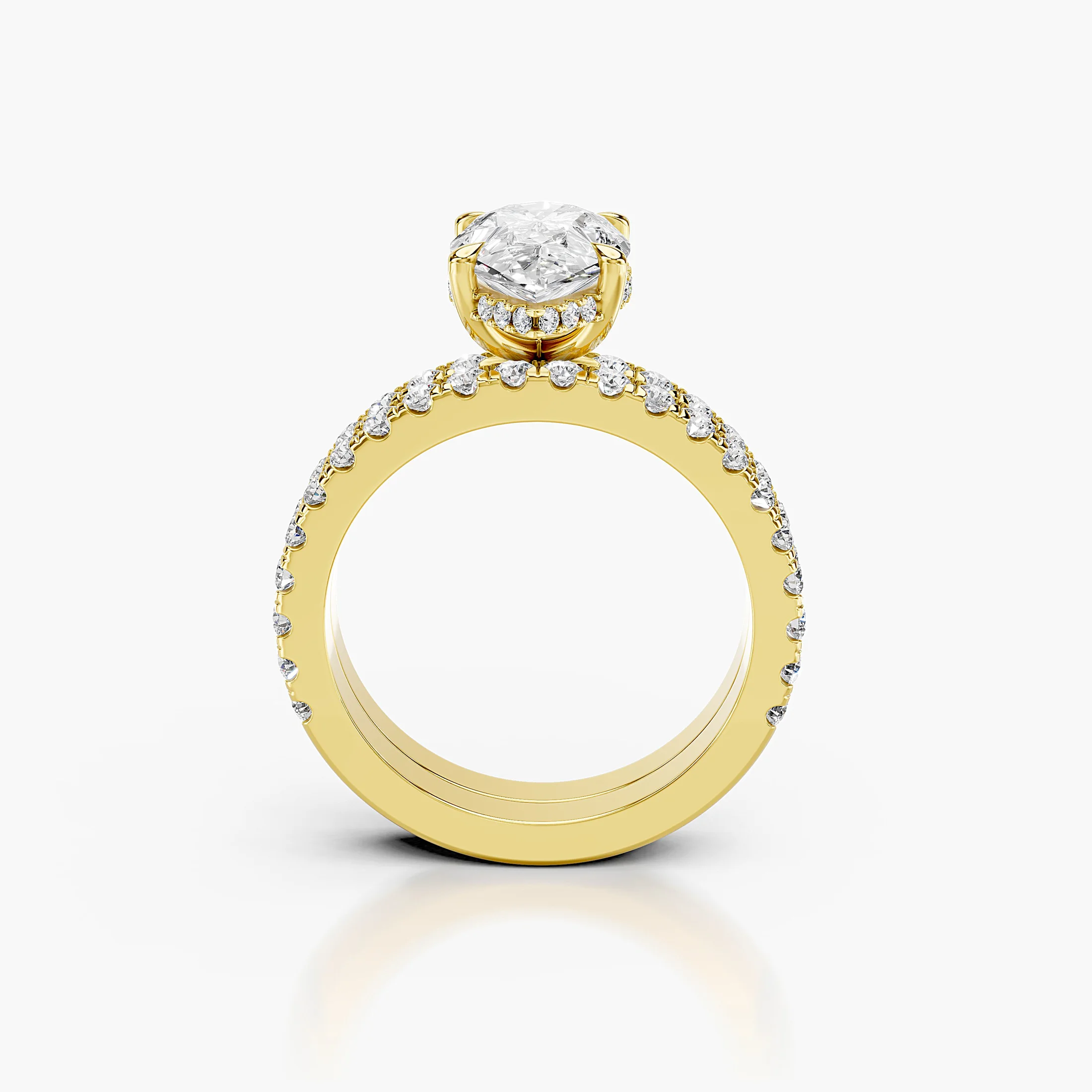 Pear-shaped hidden halo side-stone engagement ring with a coordinating straight diamond band shown as a two-piece bridal set