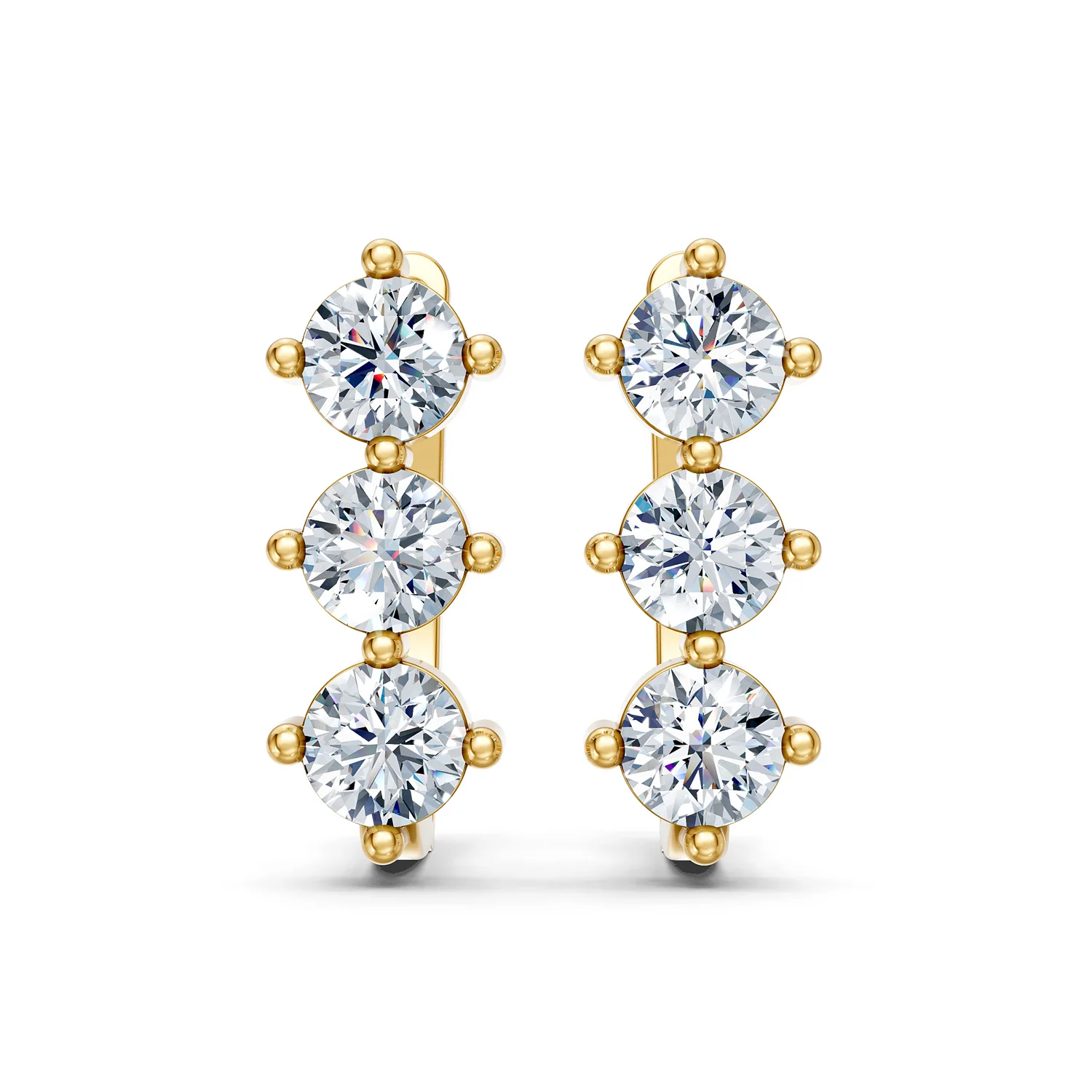 Trivessa three-stone diamond huggie earrings with vertical round diamonds and polished hinged gold frames.