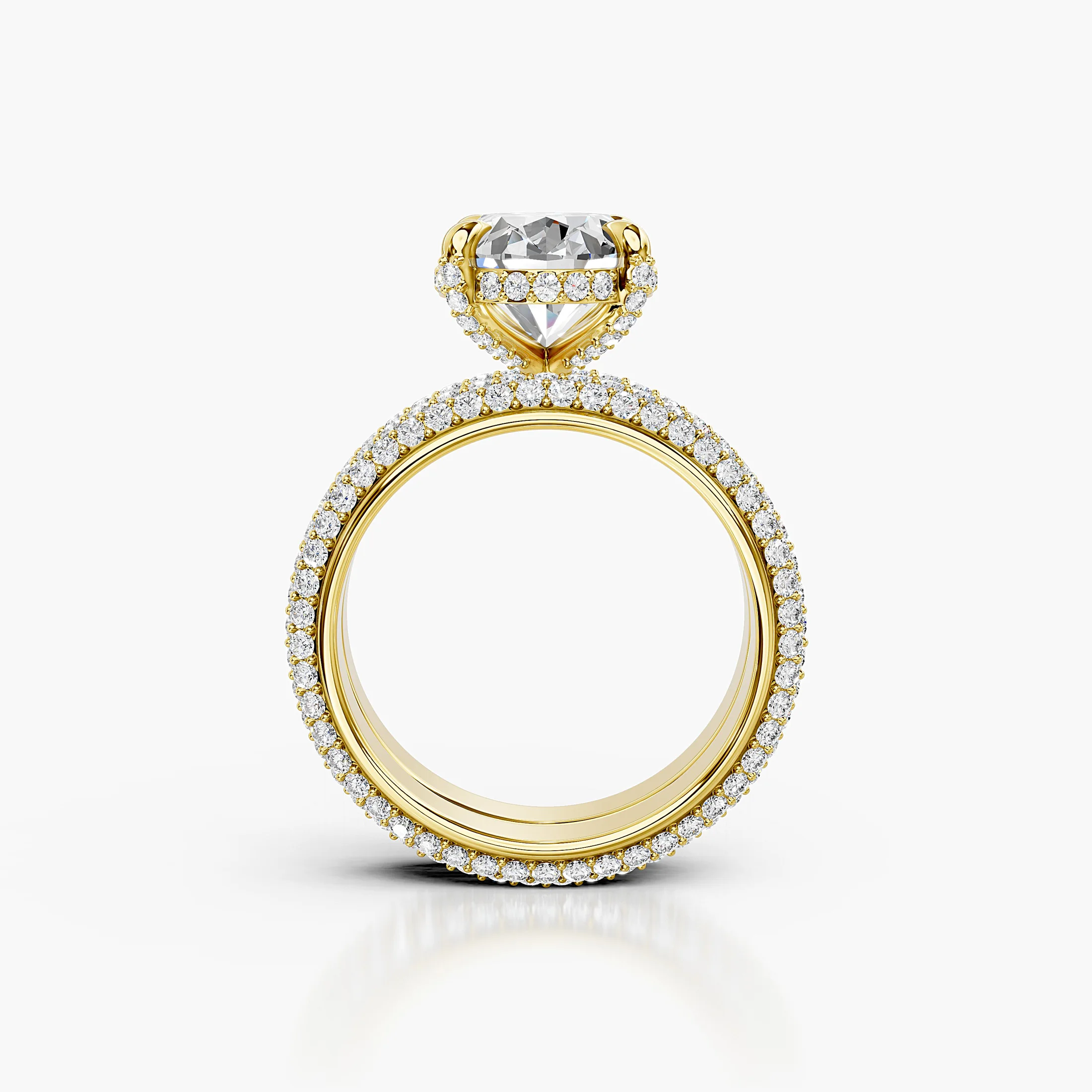 Two-piece bridal set featuring an oval-cut center stone in a pavé-set diamond band.