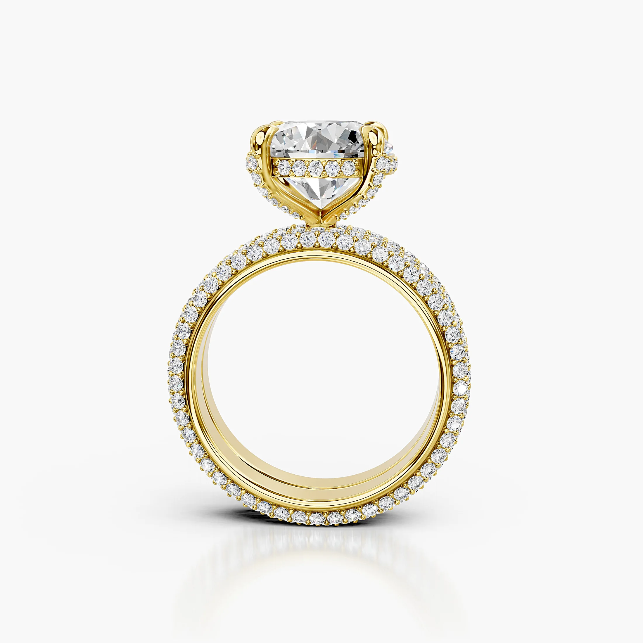 Elaris two-piece bridal ring set with a round center, raised four-prong hidden-halo setting, multi-row pavé shank, and straight coordinating band.
