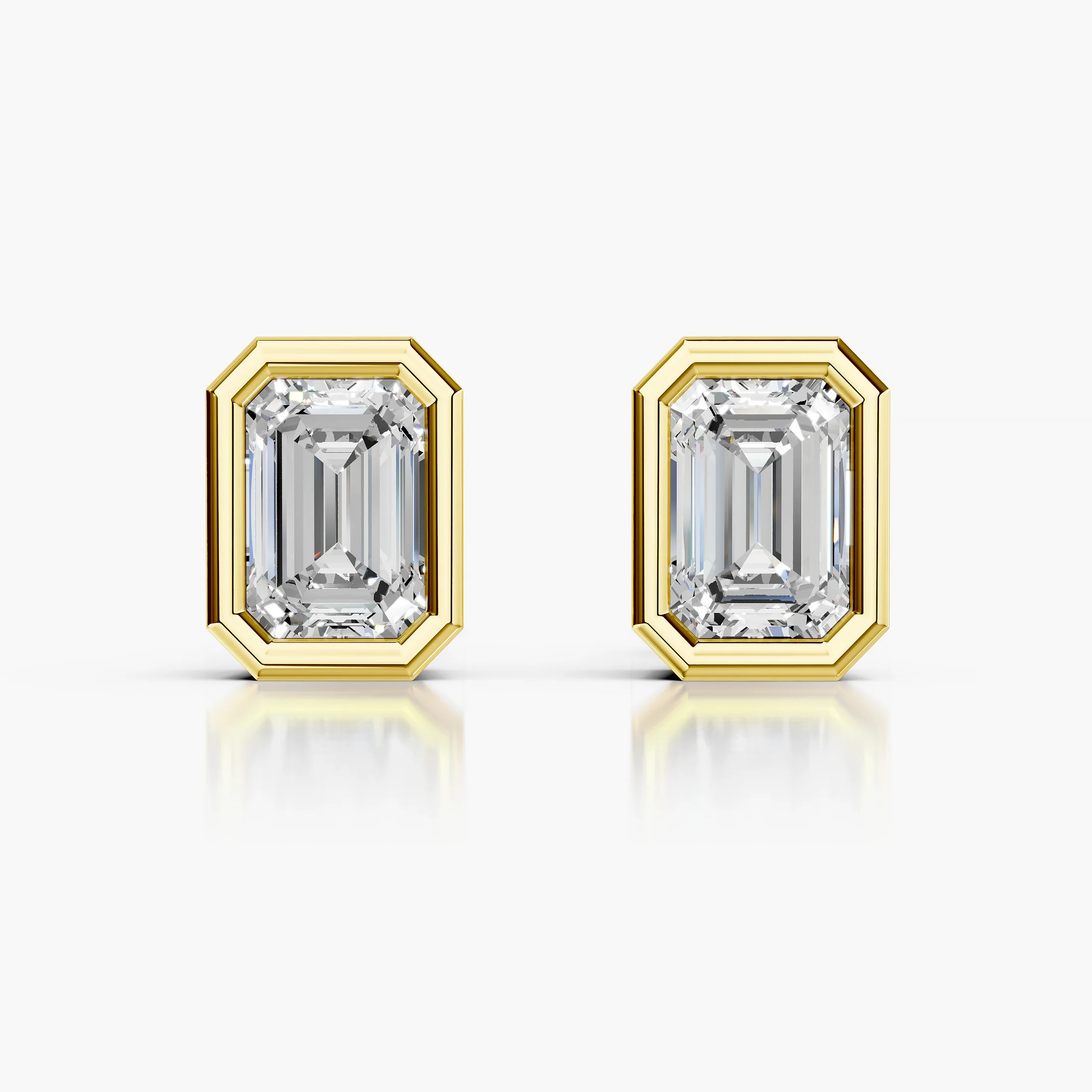 Emerald-cut diamond solitaire stud earrings with geometric bezel frames