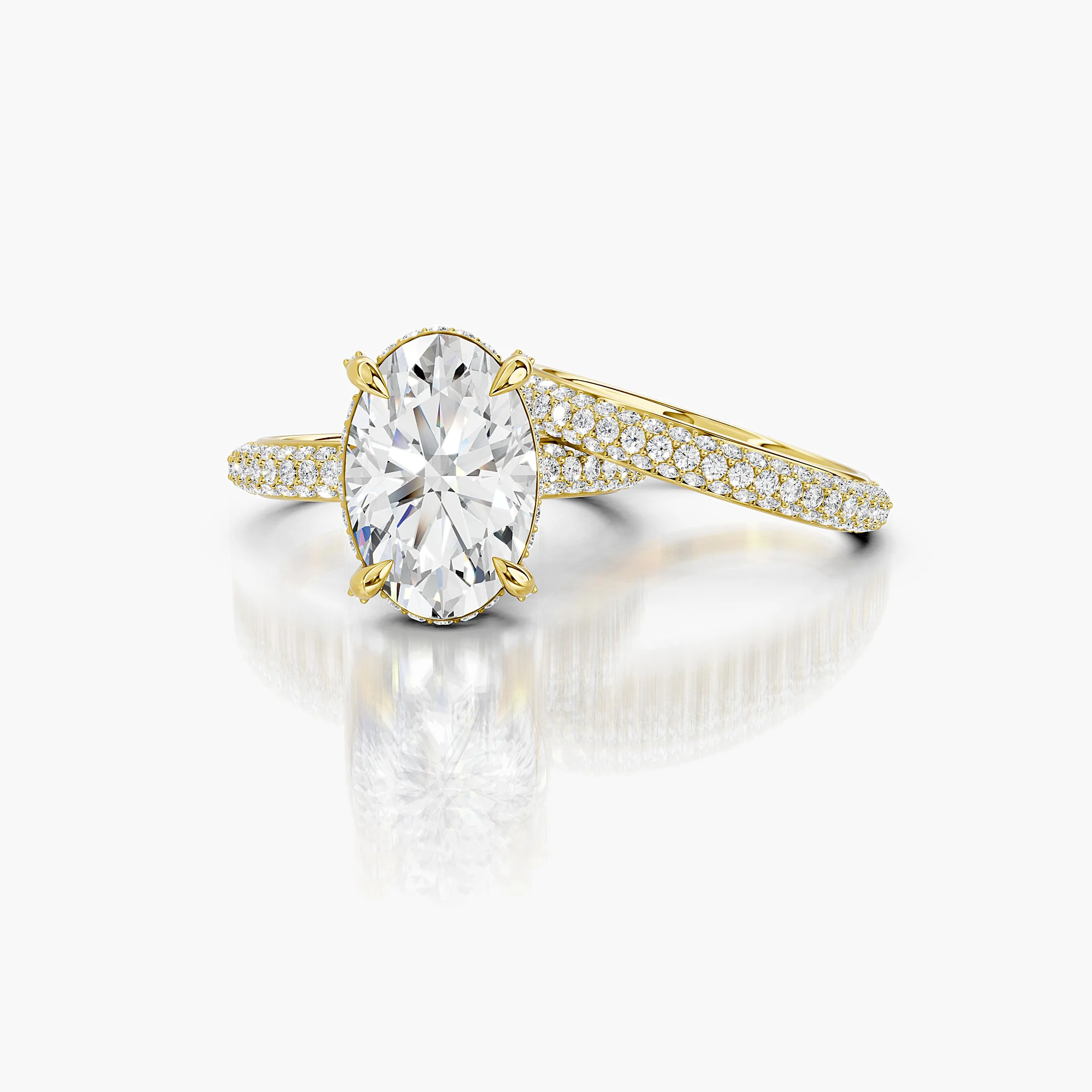 Two-piece bridal set featuring an oval-cut center stone in a pavé-set diamond band.