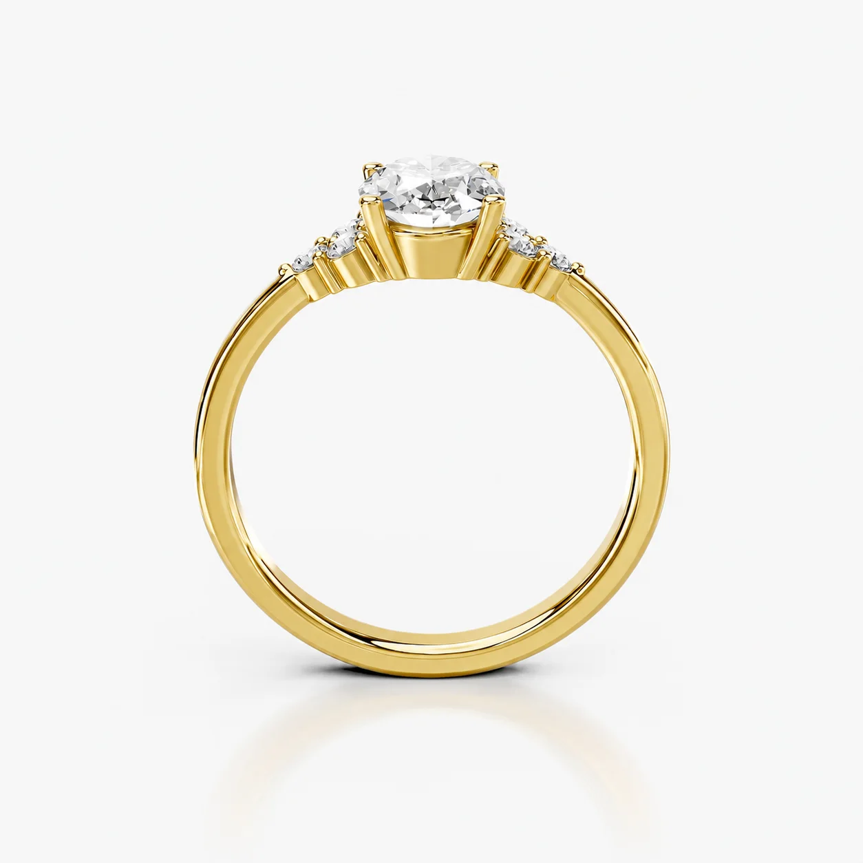 Oval four-prong engagement ring with three clustered round side stones on each shoulder and a polished tapered band.