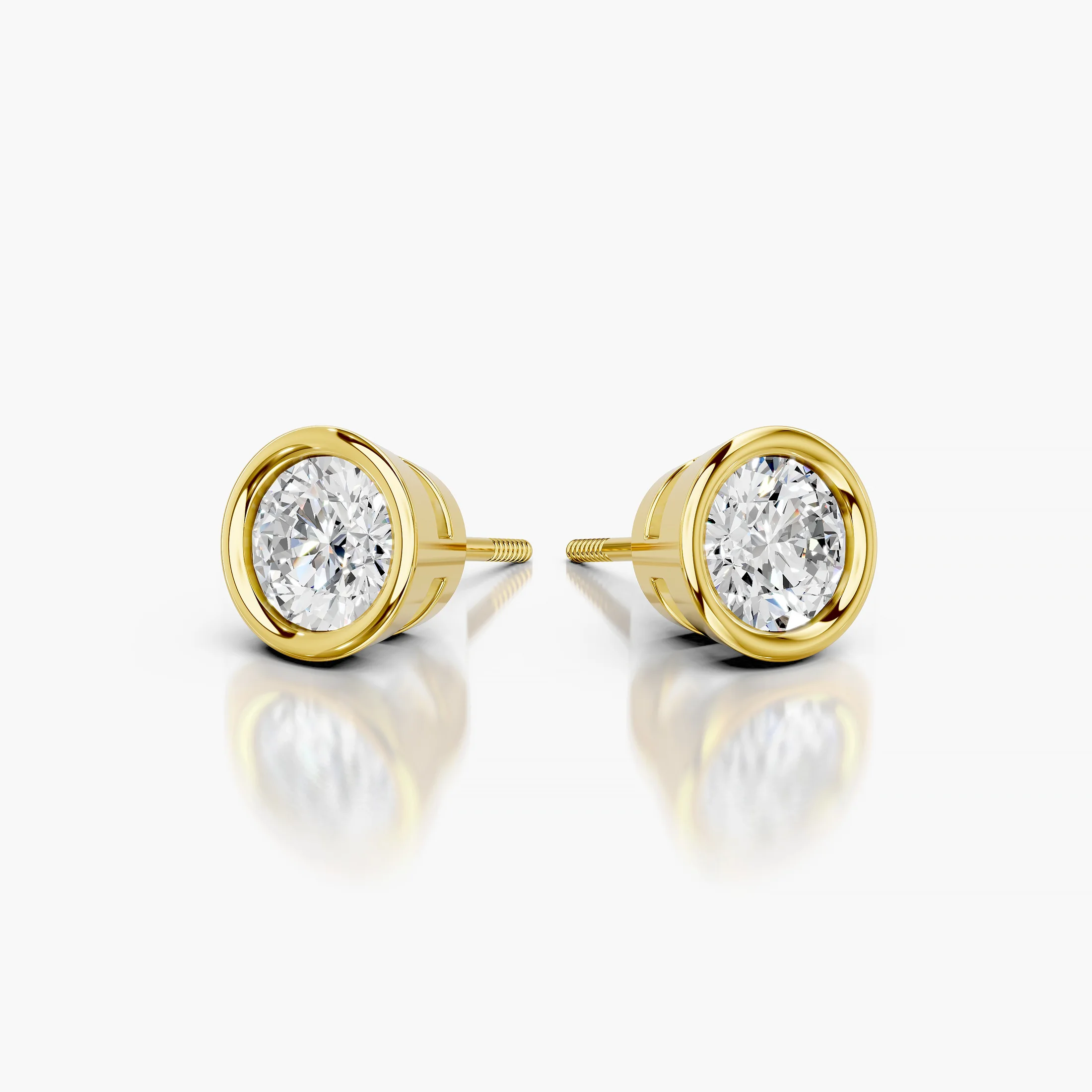 Round diamond solitaire stud earrings with smooth bezel settings
