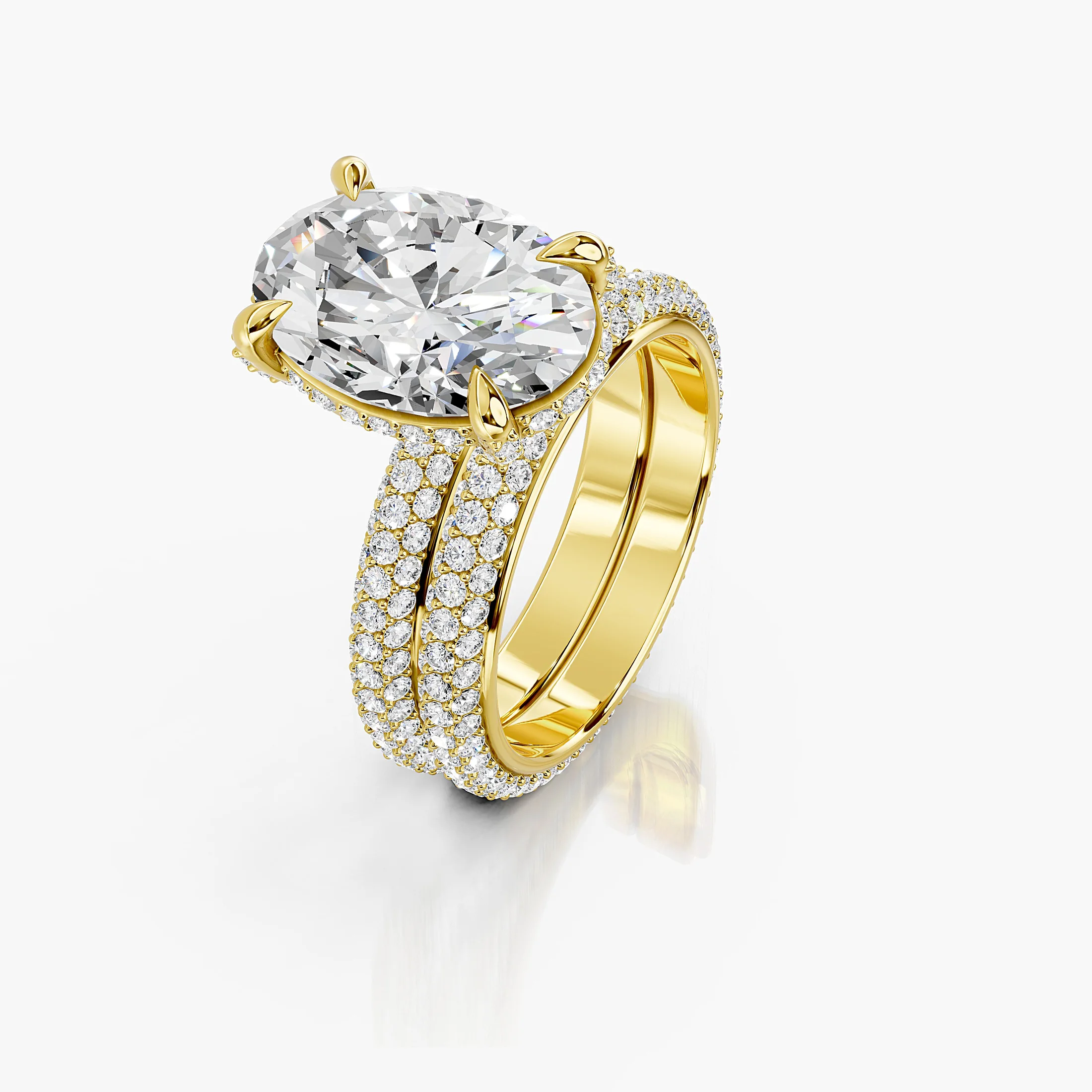 Two-piece bridal set featuring an oval-cut center stone in a pavé-set diamond band.
