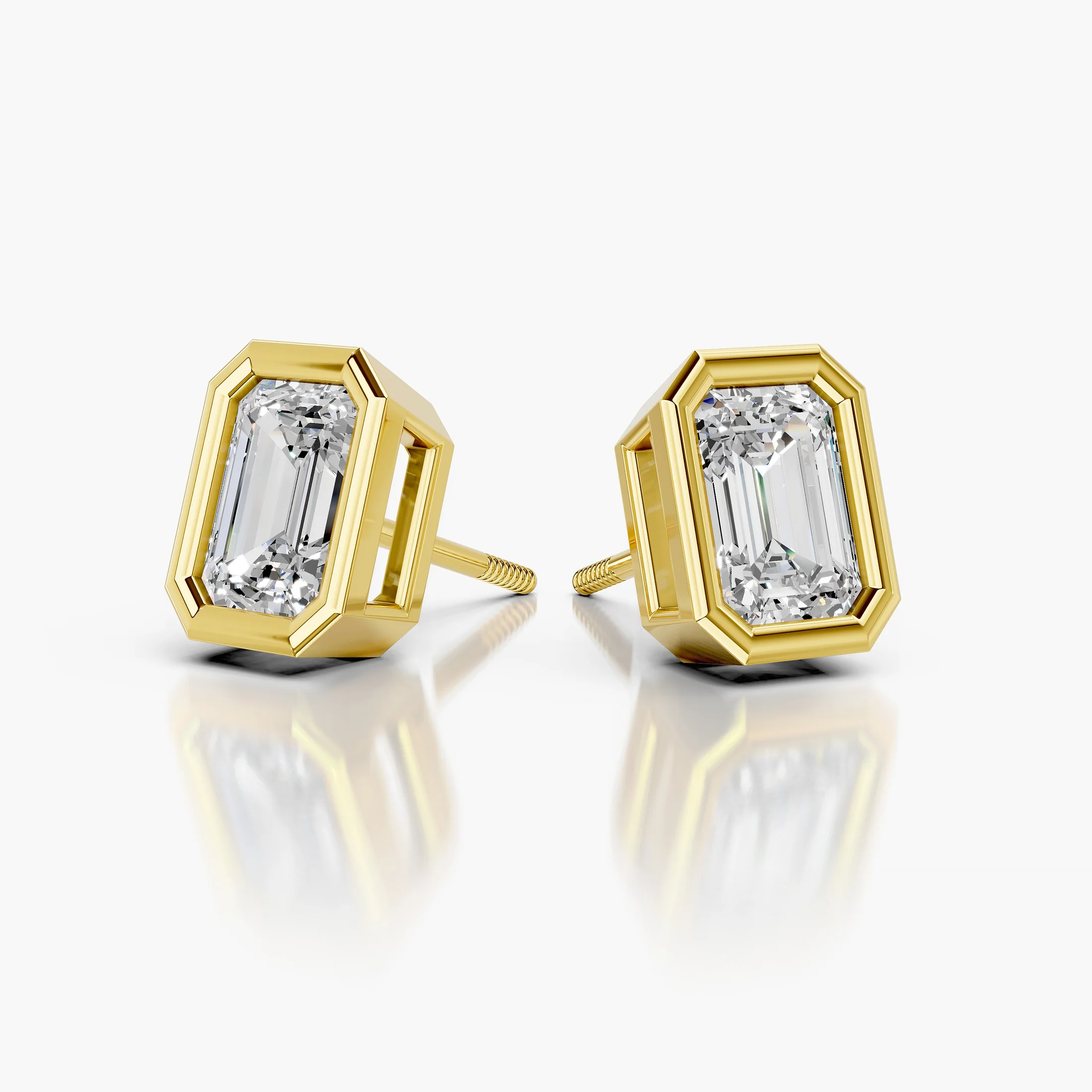 Emerald-cut diamond solitaire stud earrings with geometric bezel frames