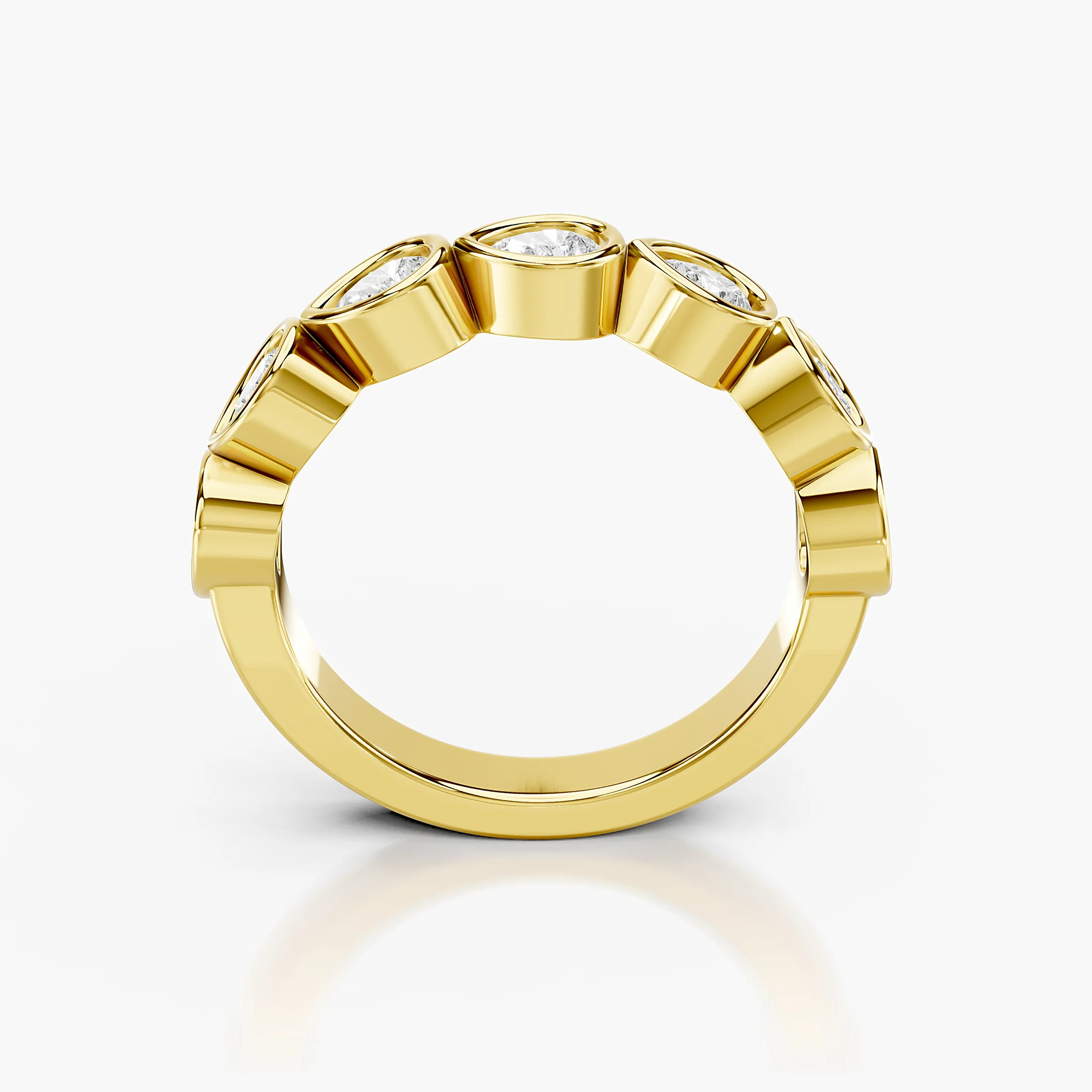 Wedding band featuring bezel-set pear-shaped diamonds arranged across a polished gold band.