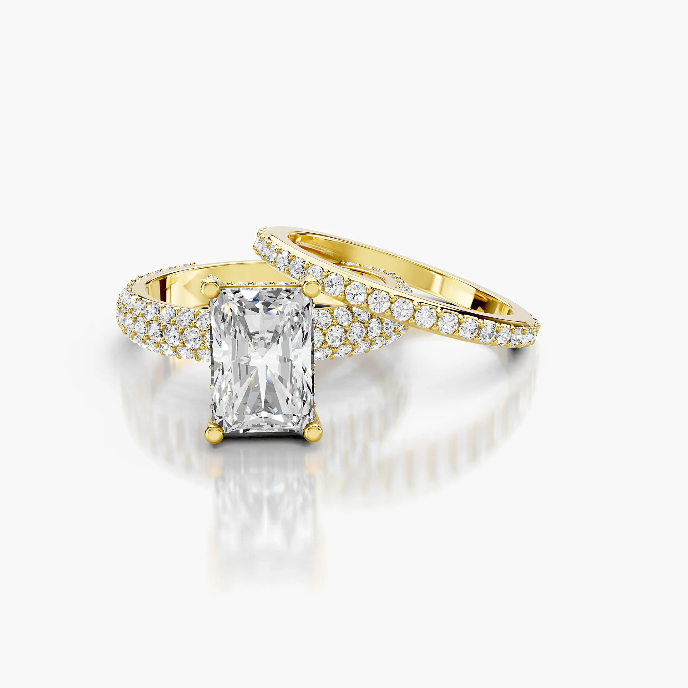 Radiant diamond pavé bridal set with a four-prong center and coordinating straight diamond band