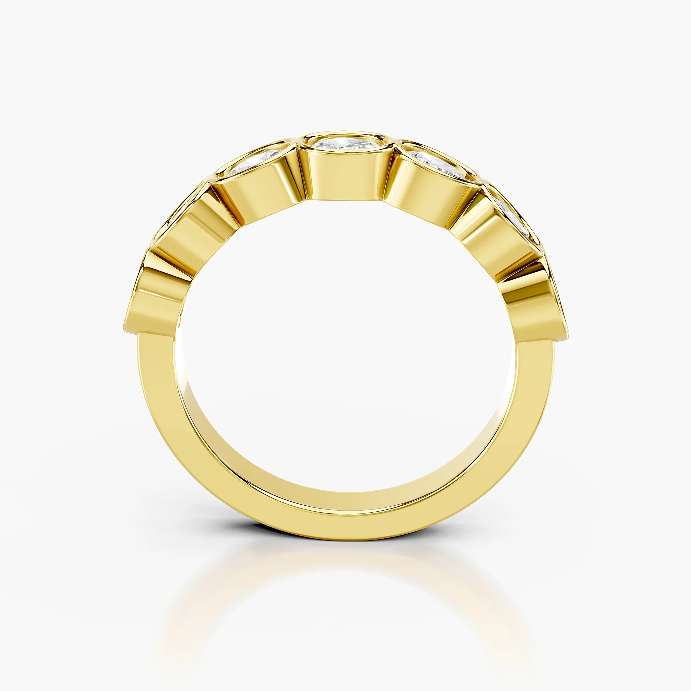 Wedding band featuring bezel-set oval diamonds arranged across a polished gold band.