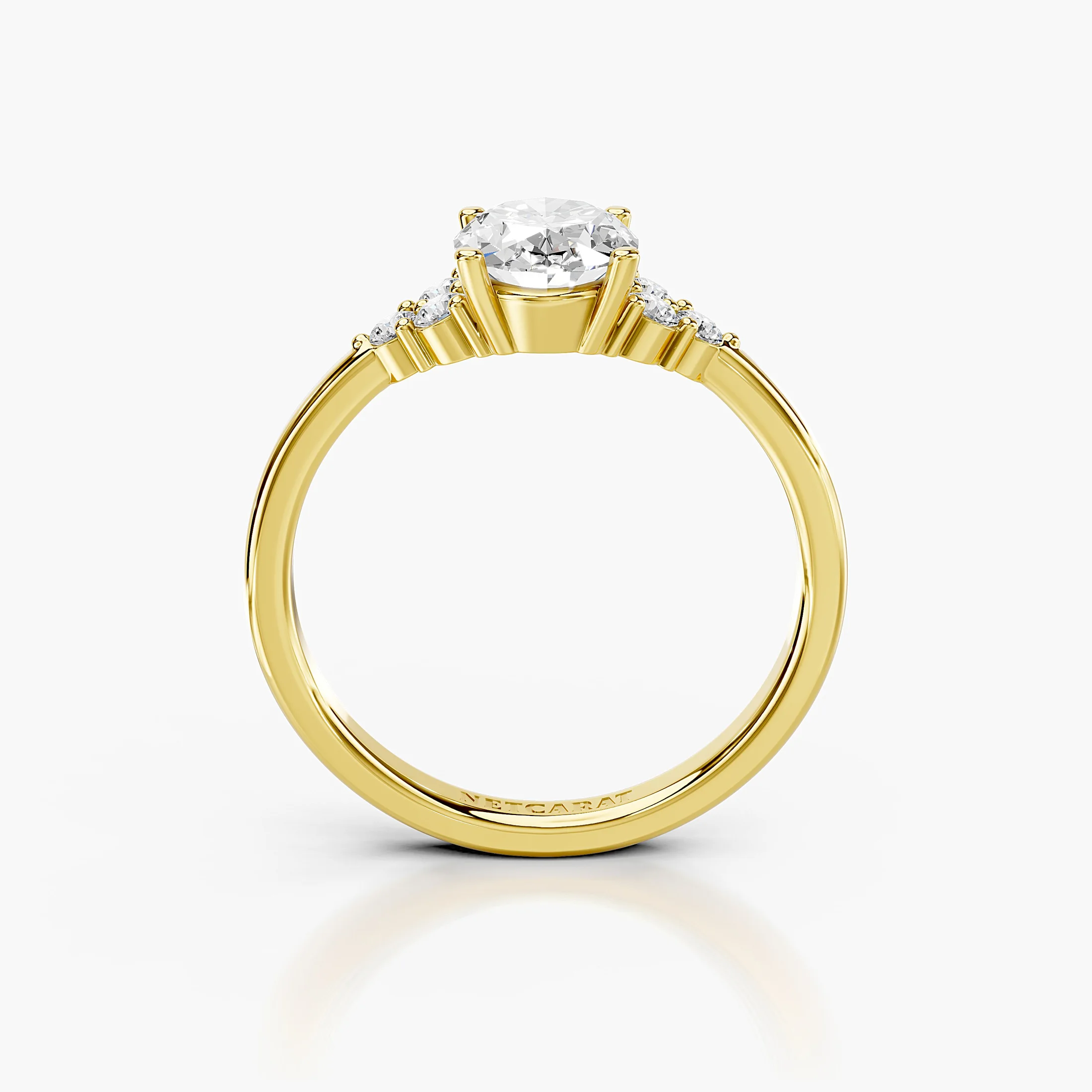 Oval four-prong engagement ring with three clustered round side stones on each shoulder and a polished tapered band.