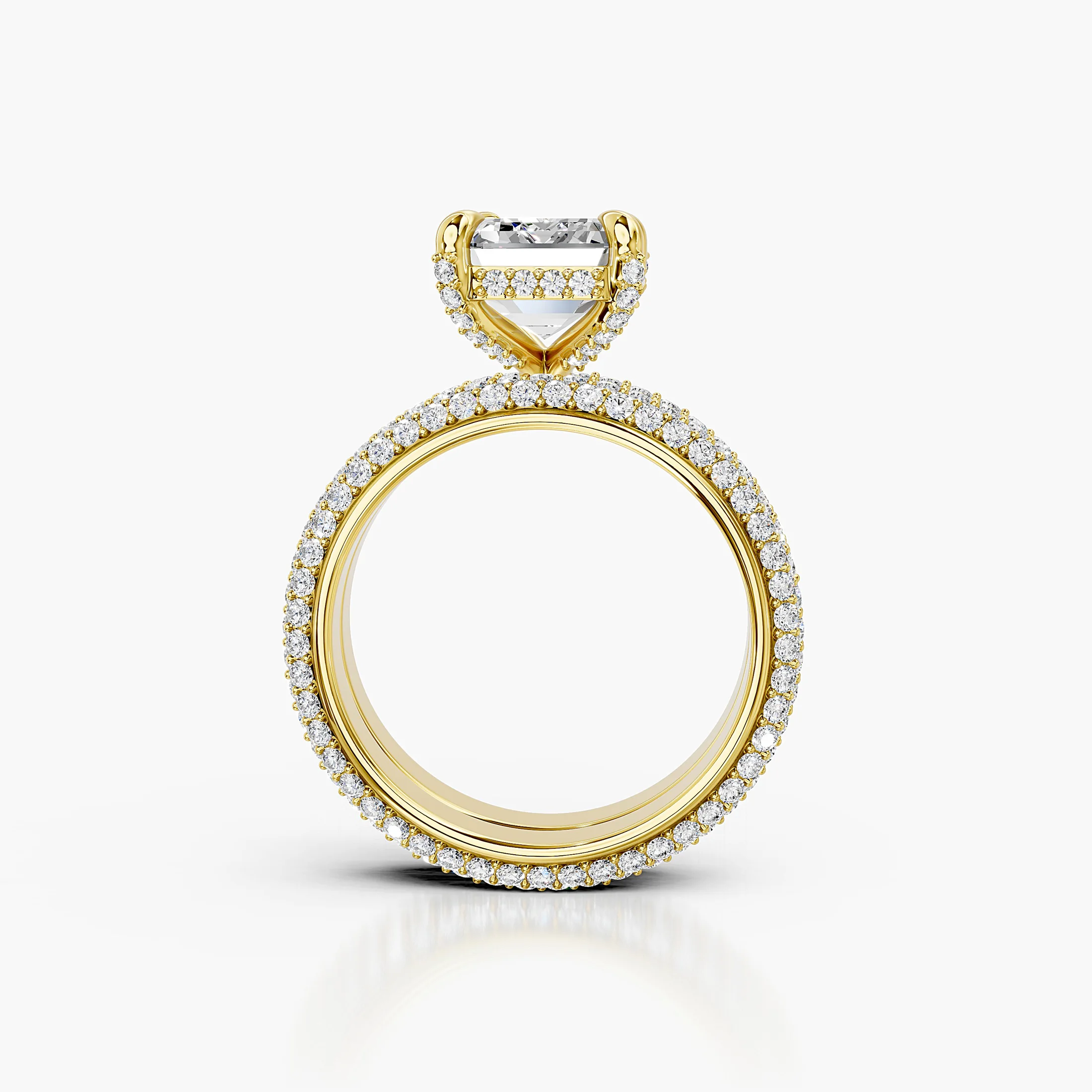 Two-piece bridal set featuring an emerald-cut center stone in a pavé-set diamond band.