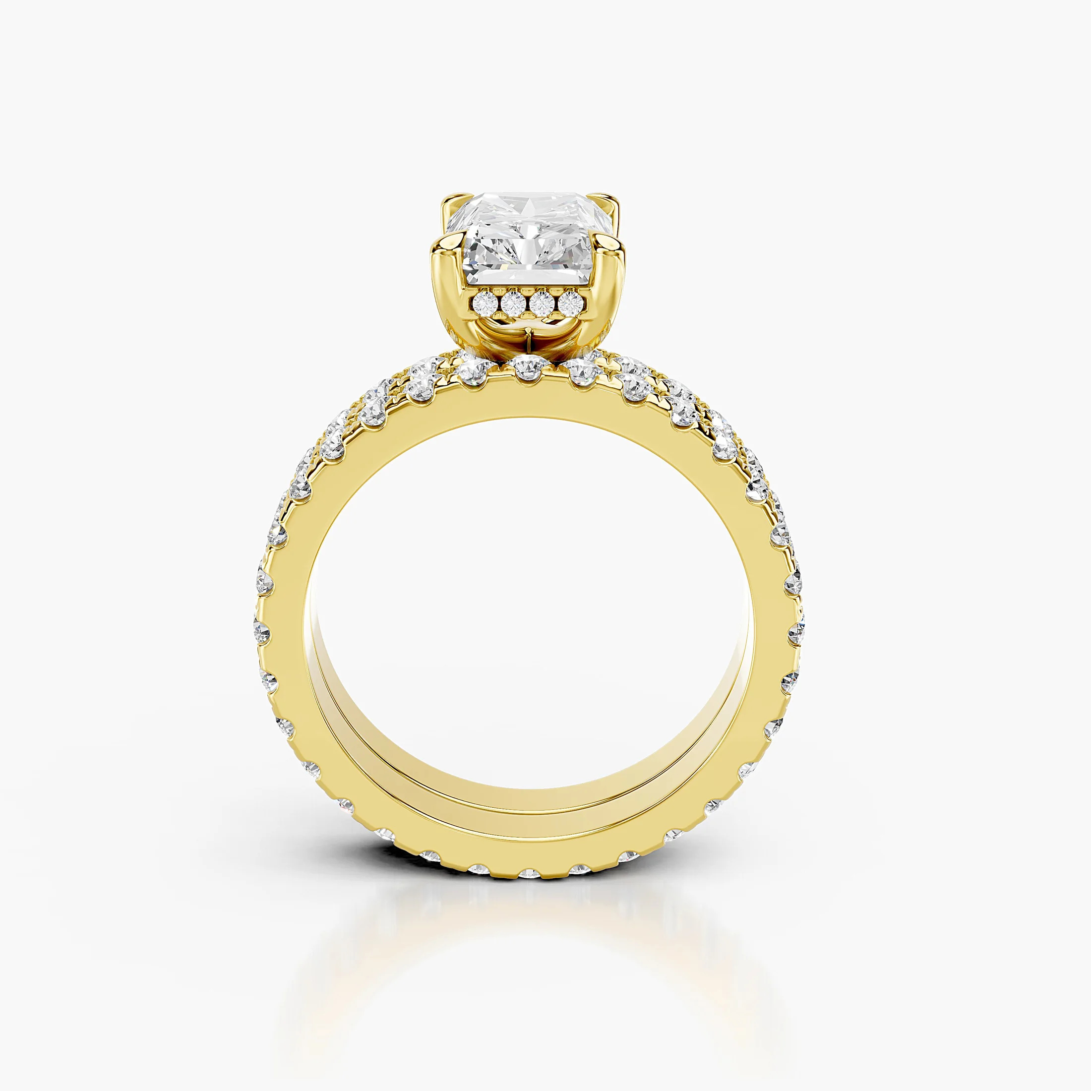 Radiant-cut hidden halo side-stone engagement ring with a coordinating straight diamond band shown as a two-piece bridal set