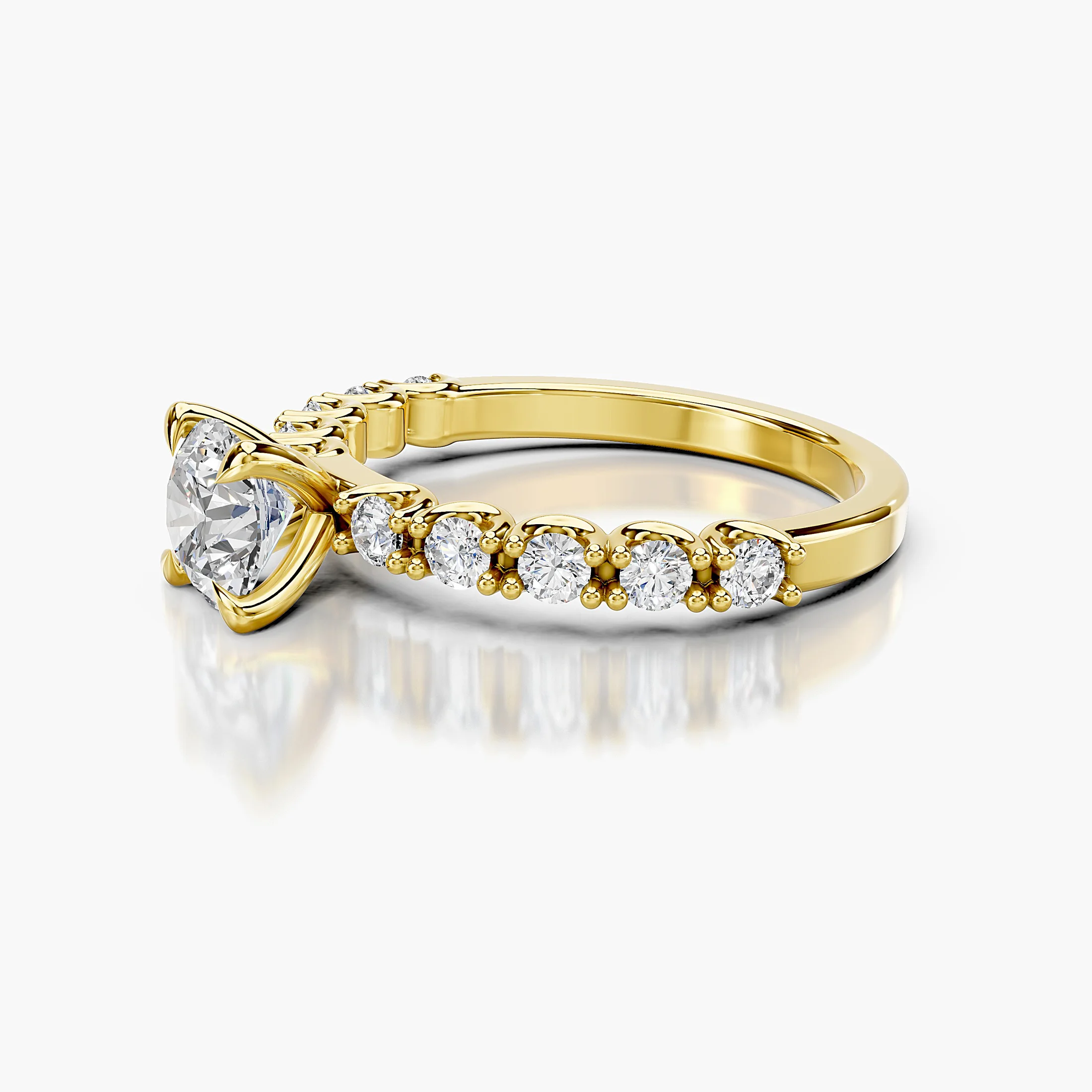 Round center-stone engagement ring with graduated round diamonds set along the shank.