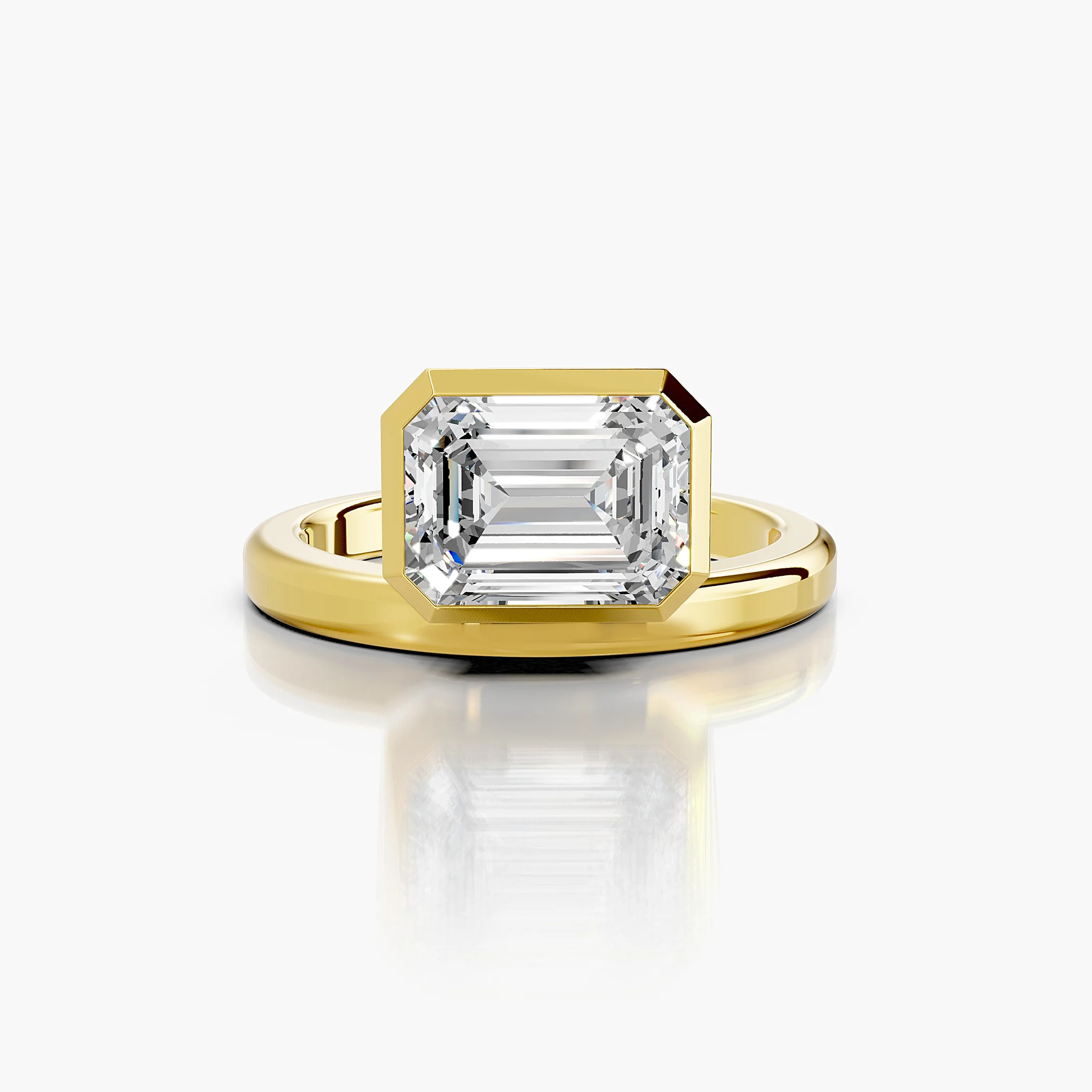 Emerald-cut diamond solitaire ring set in a bold bezel on a wide polished band.