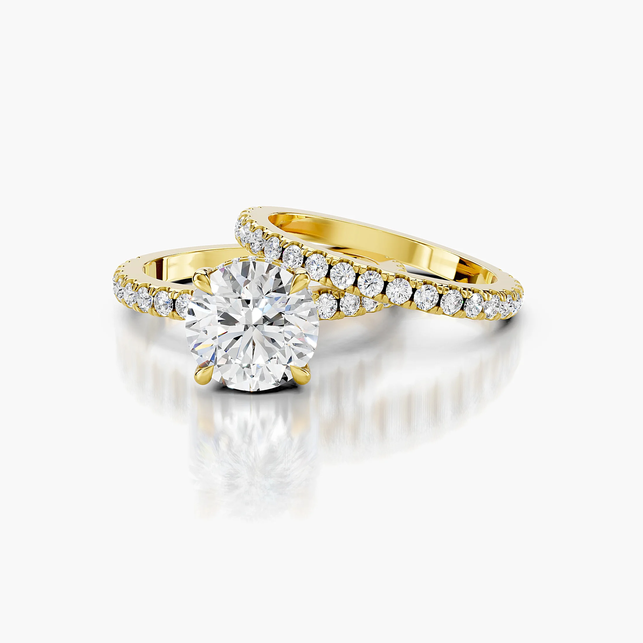Round hidden halo side-stone engagement ring with a coordinating straight diamond band shown as a two-piece bridal set