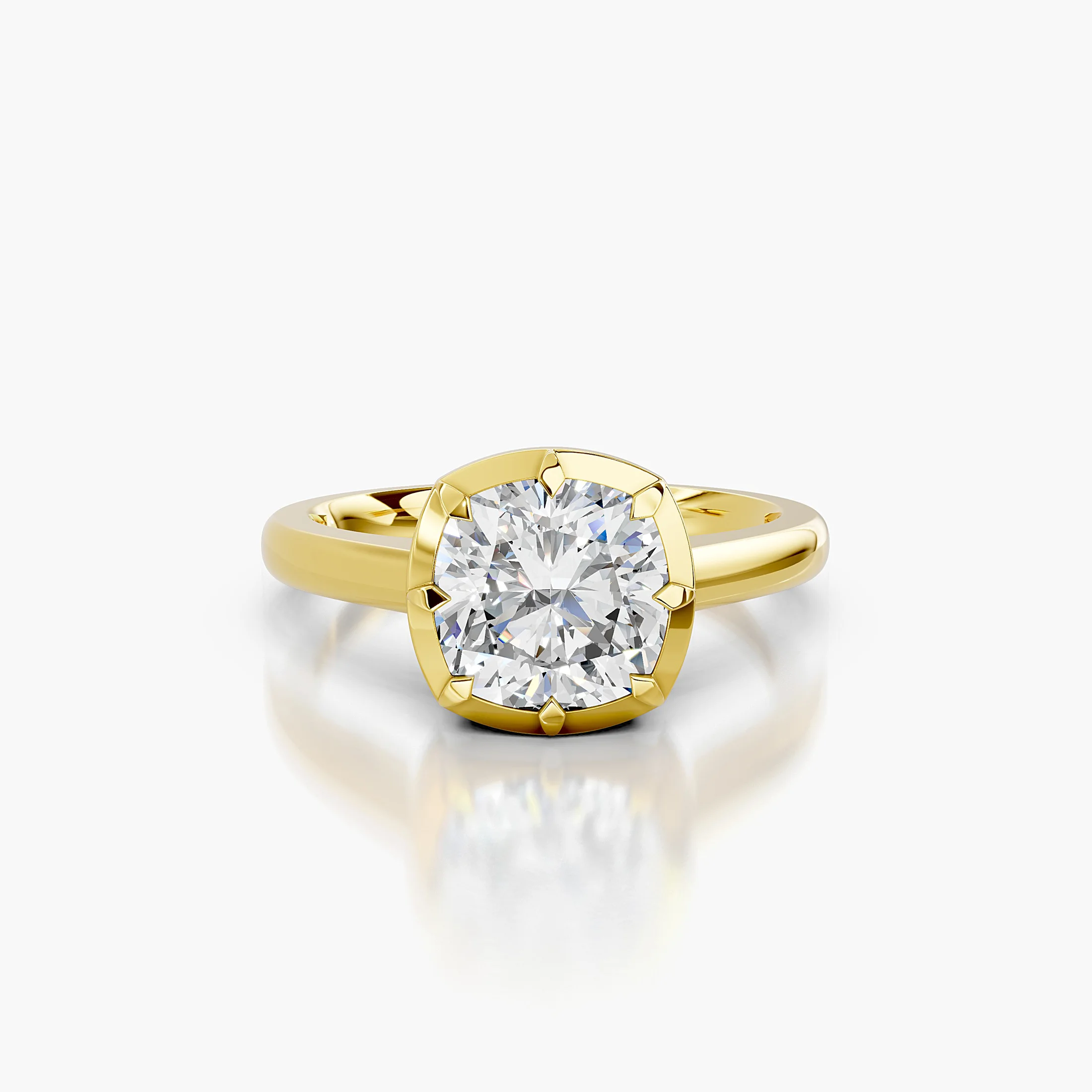 Cushion-cut diamond solitaire ring set in a notched bezel on a polished gold band.