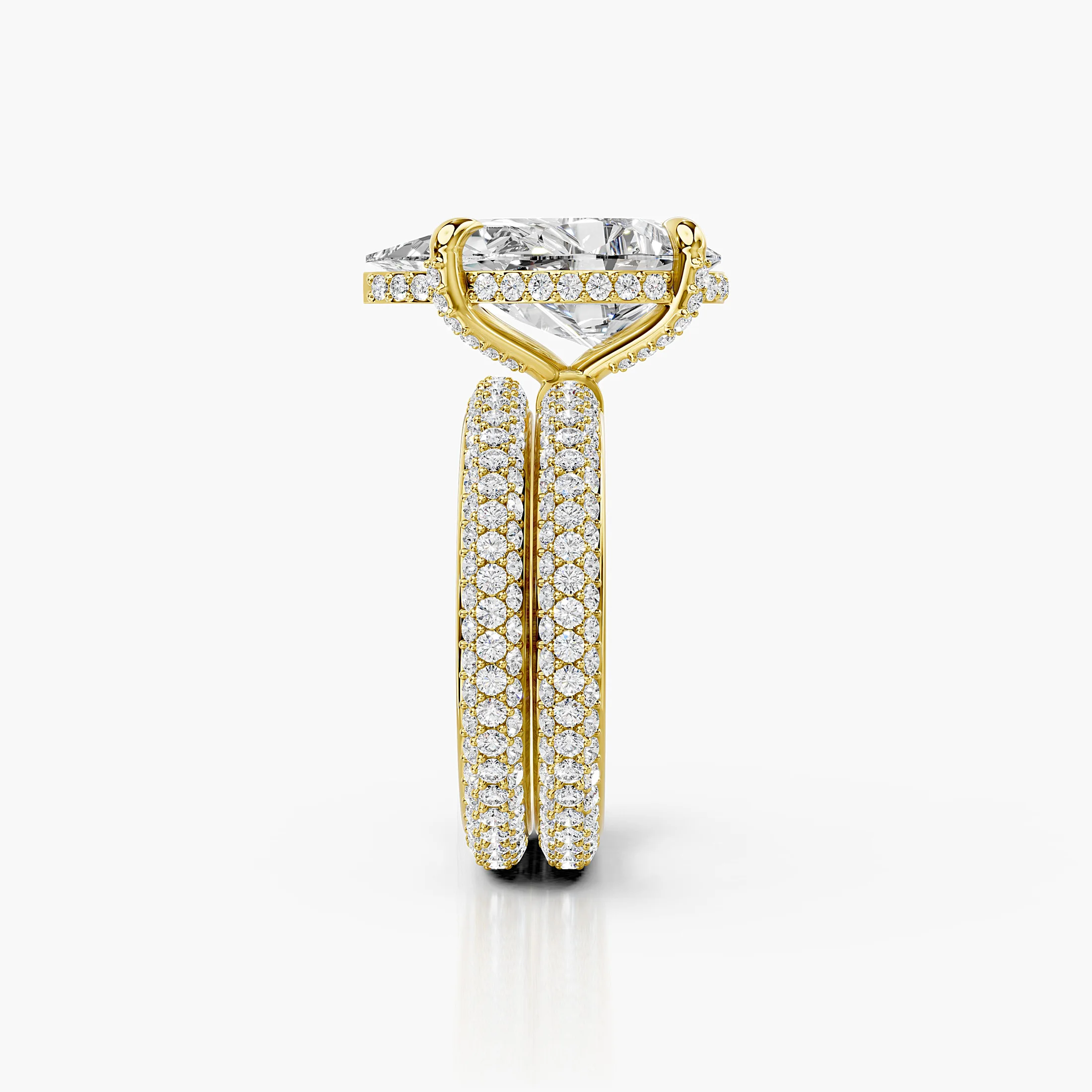 Pear-shaped center in a four-prong hidden-halo bridal set with round pavé shanks and a straight coordinating diamond band.