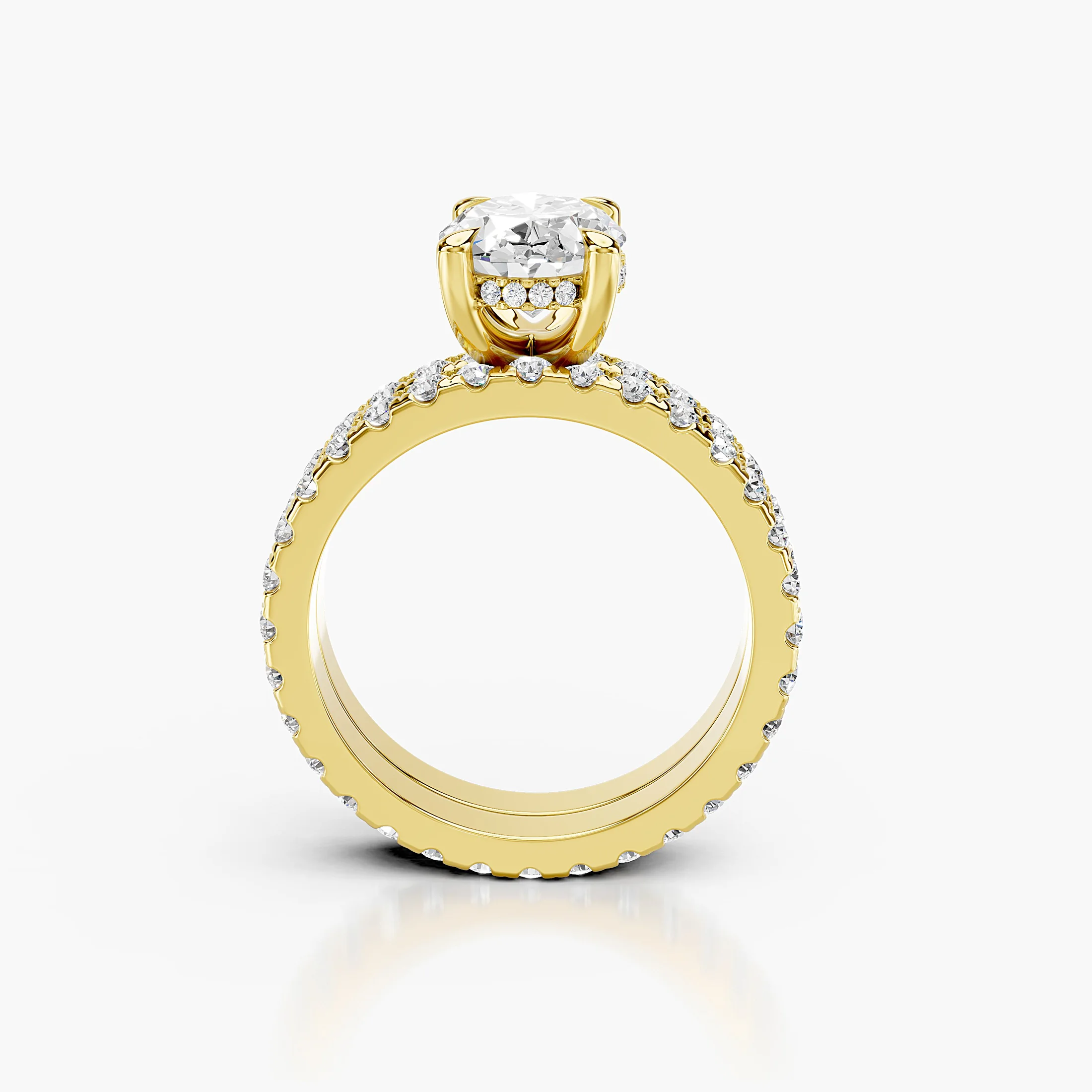 Oval diamond hidden halo engagement ring with round side stones and a straight coordinating diamond wedding band