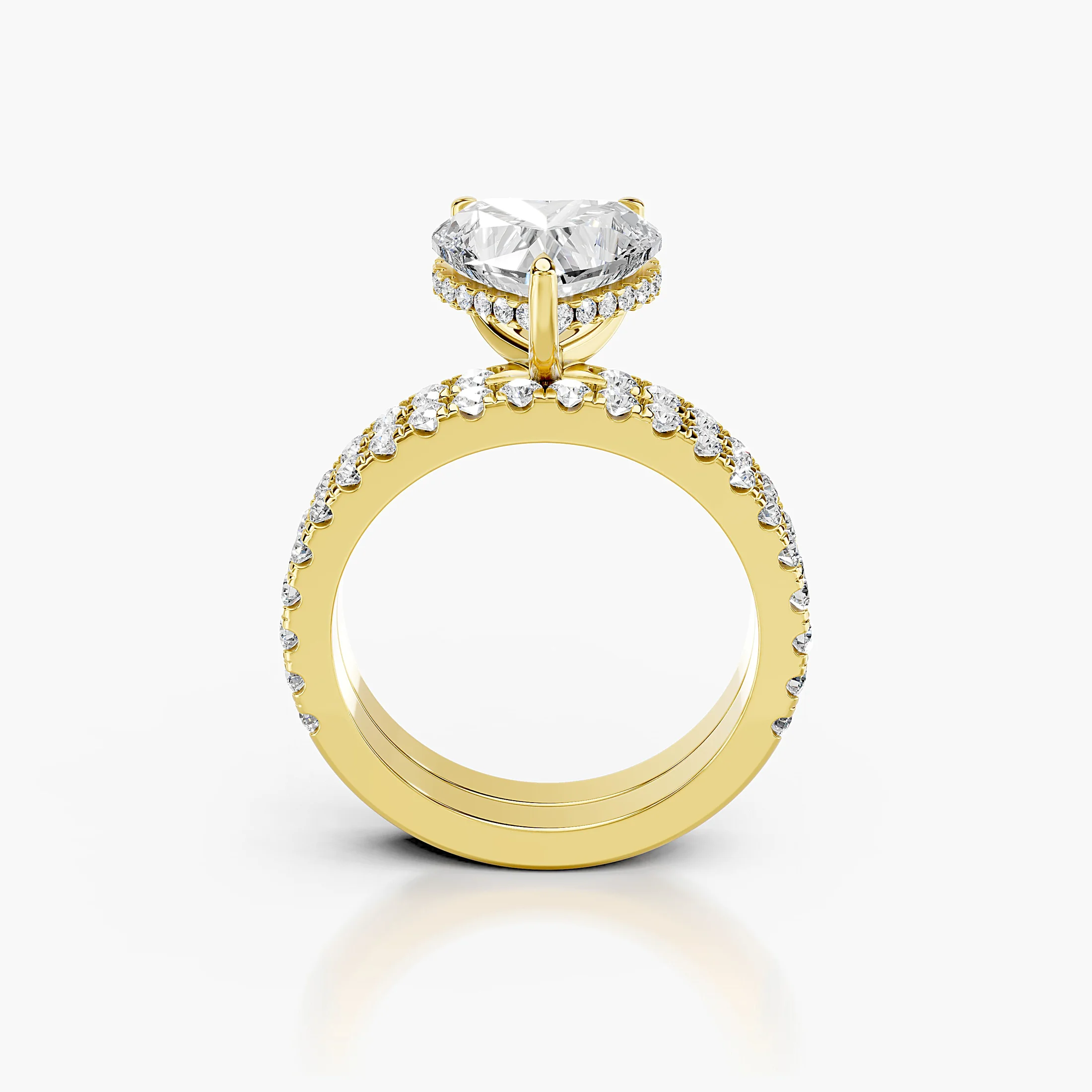 Heart-shaped engagement ring with hidden halo, round side stones, and straight coordinating diamond wedding band