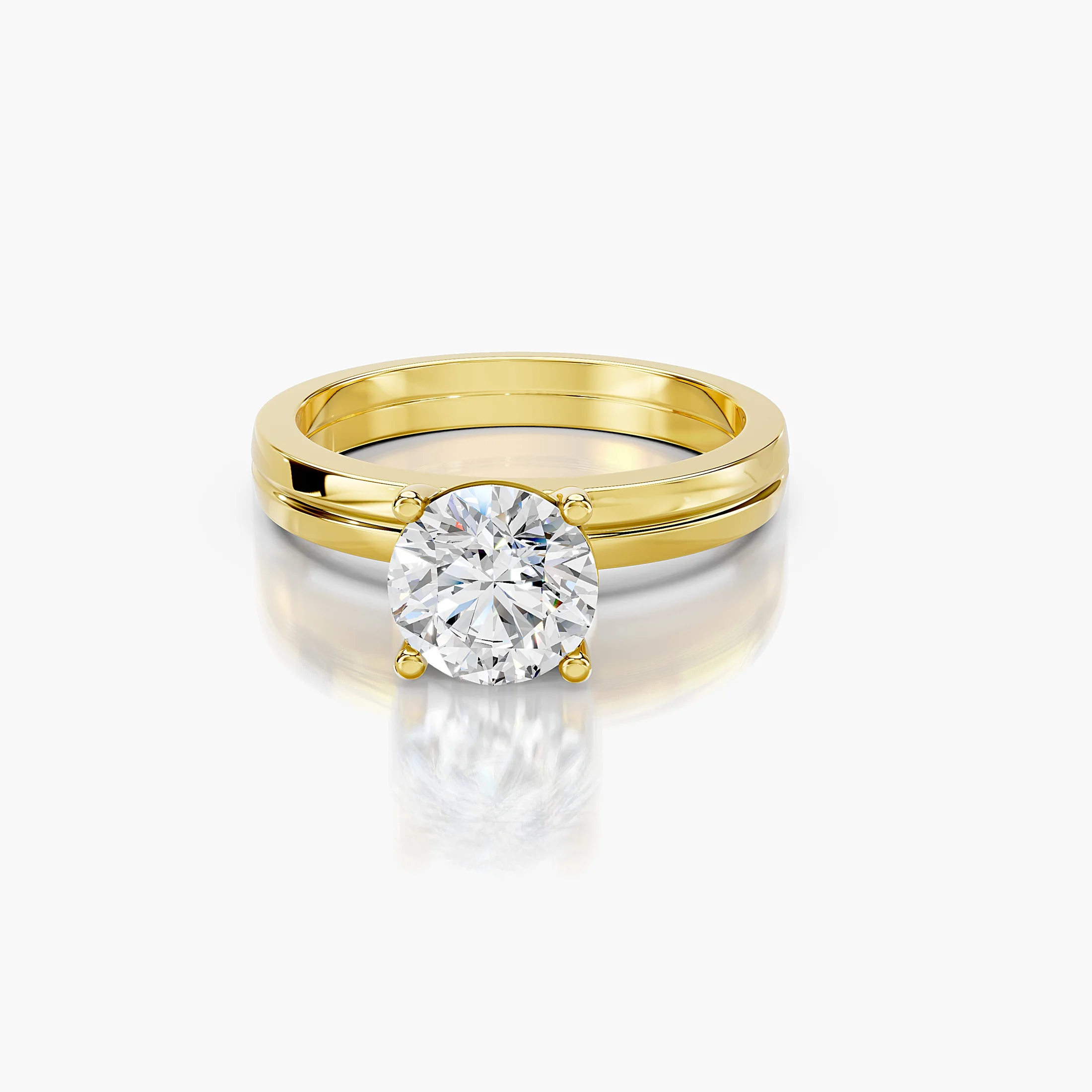 Round diamond solitaire ring on a grooved, split-profile gold band.