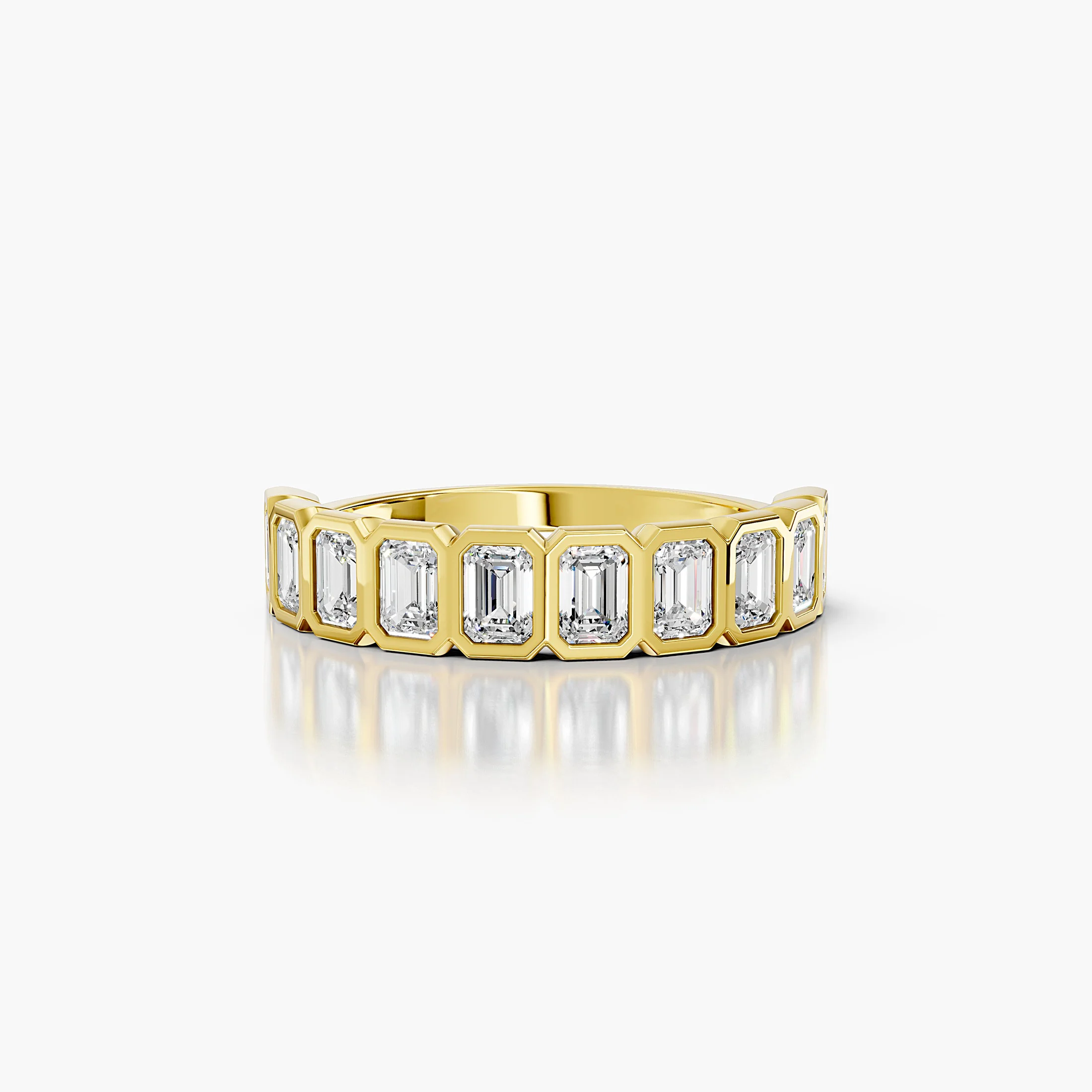 Half-eternity band featuring emerald-cut diamonds set in individual bezels across the ring.