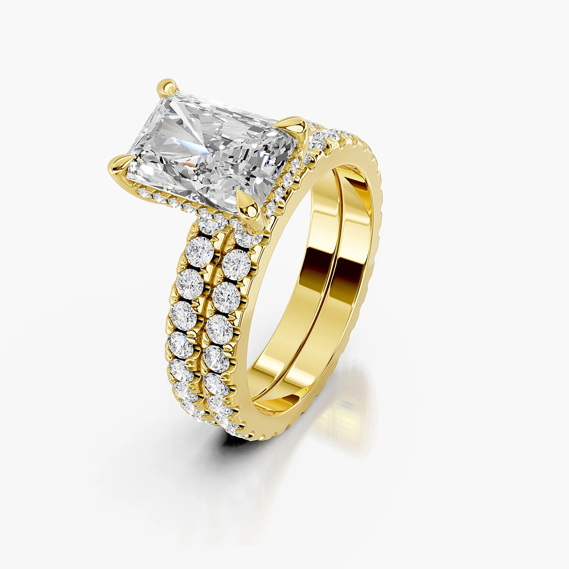 Radiant-cut hidden halo side-stone engagement ring with a coordinating straight diamond band shown as a two-piece bridal set