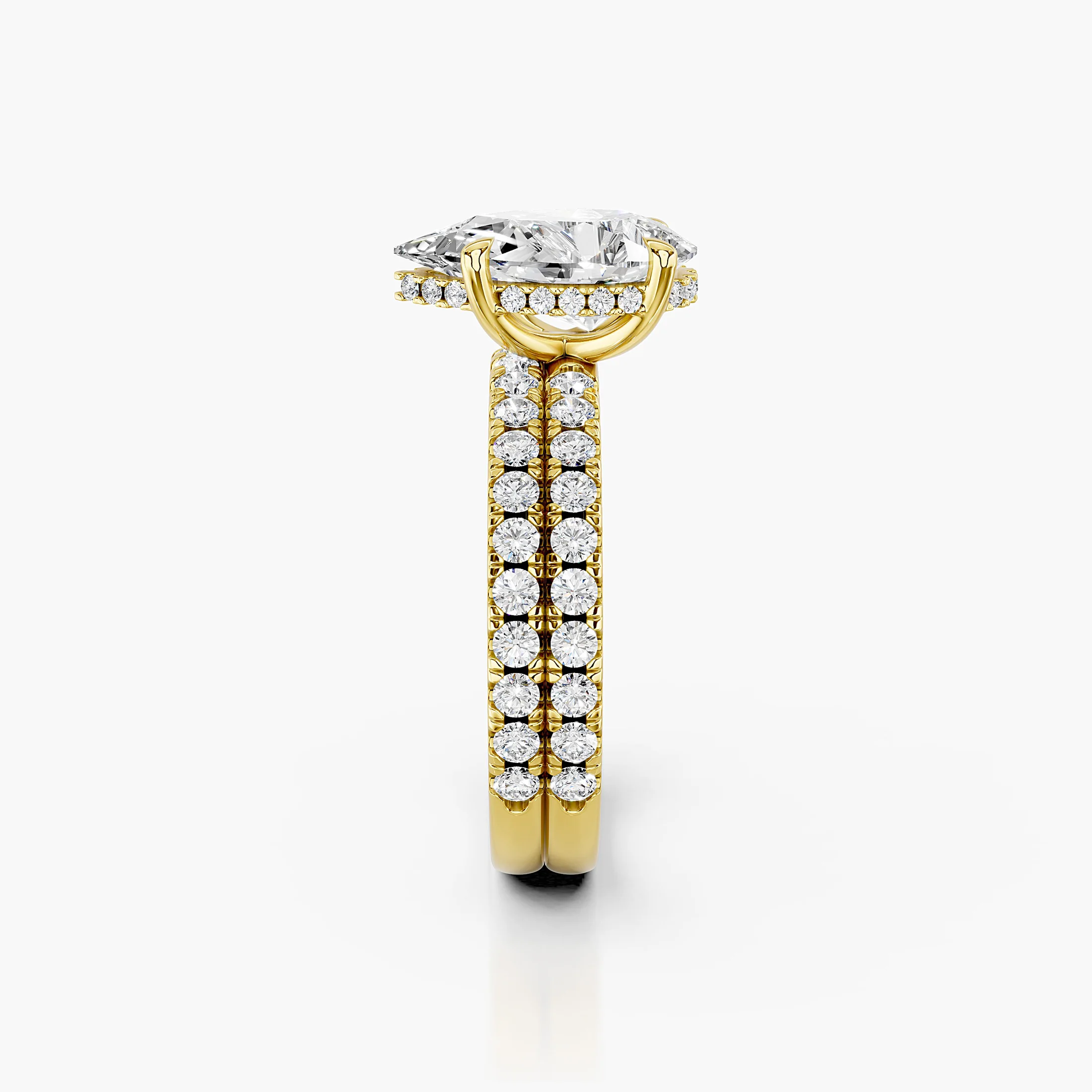 Pear-shaped hidden halo side-stone engagement ring with a coordinating straight diamond band shown as a two-piece bridal set