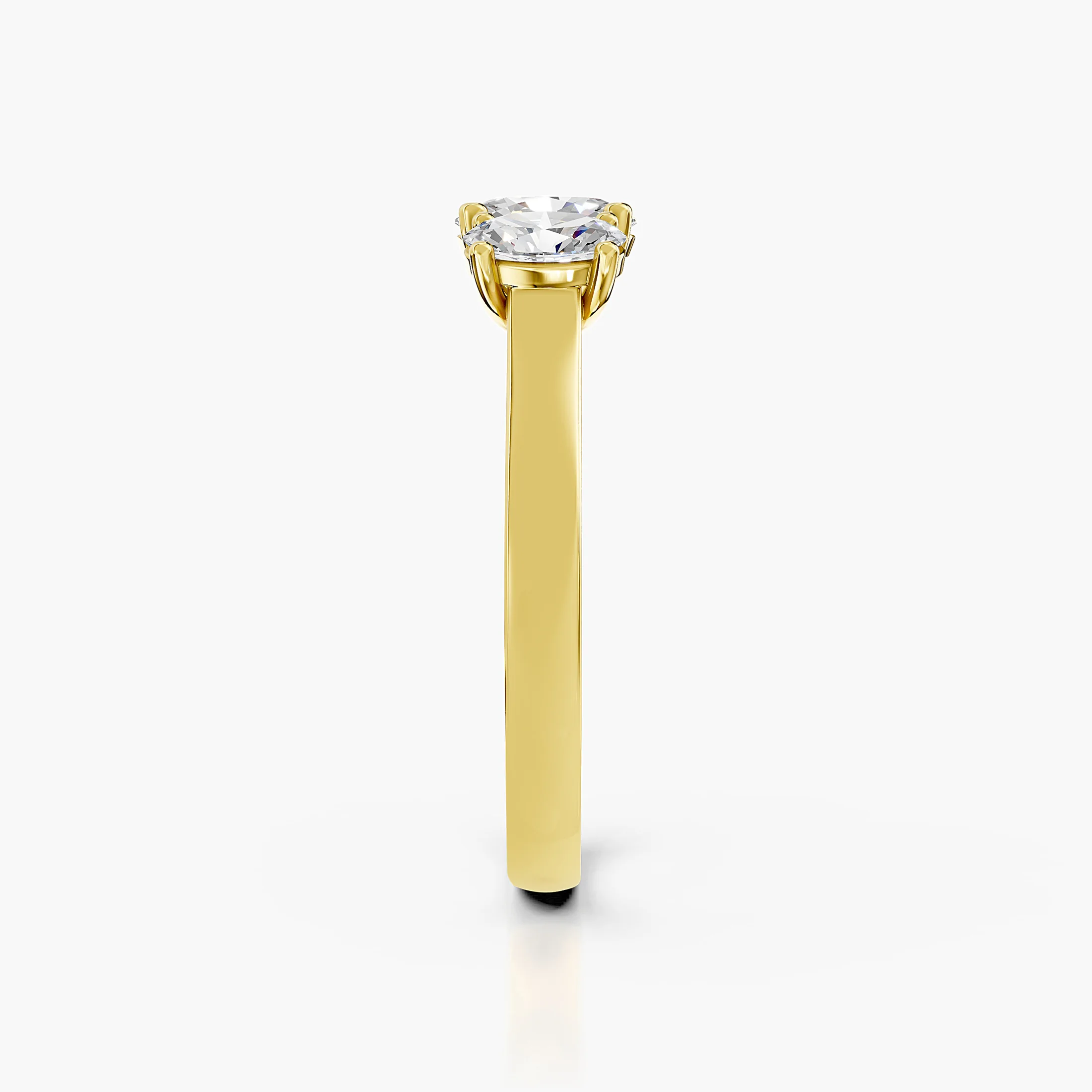 Three-stone engagement ring featuring a center oval diamond flanked by two matching oval diamonds.