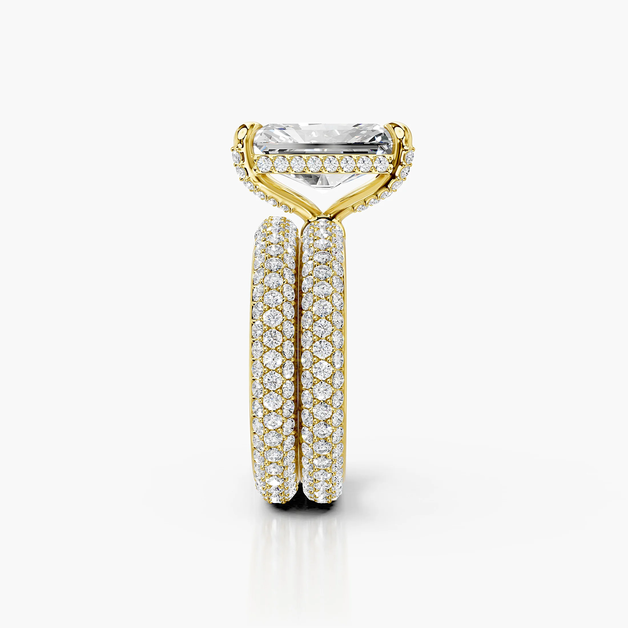 Solenne two-piece bridal ring set with an elongated radiant center, four-prong hidden-halo setting, multi-row round pavé, and straight coordinating band.