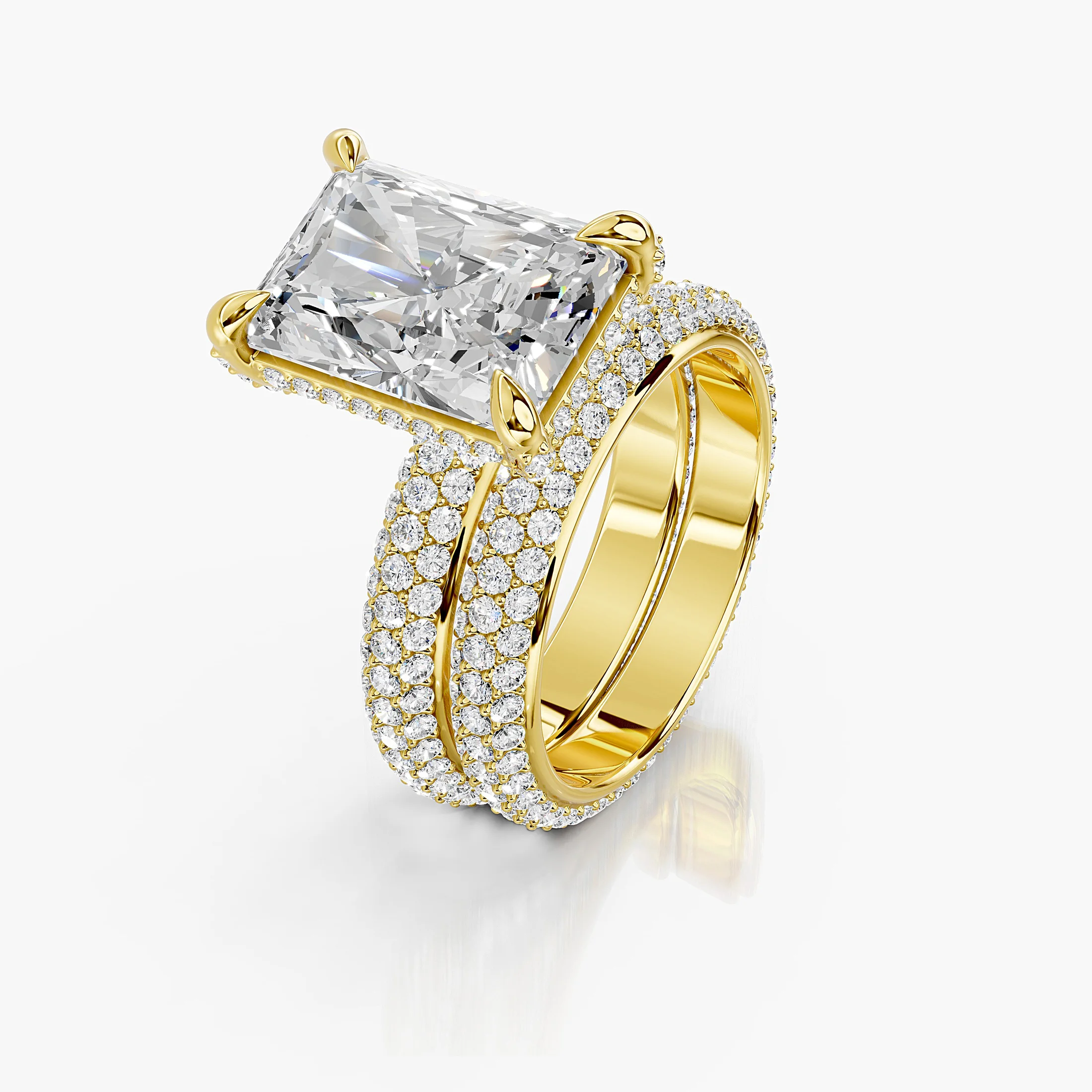 Solenne two-piece bridal ring set with an elongated radiant center, four-prong hidden-halo setting, multi-row round pavé, and straight coordinating band.