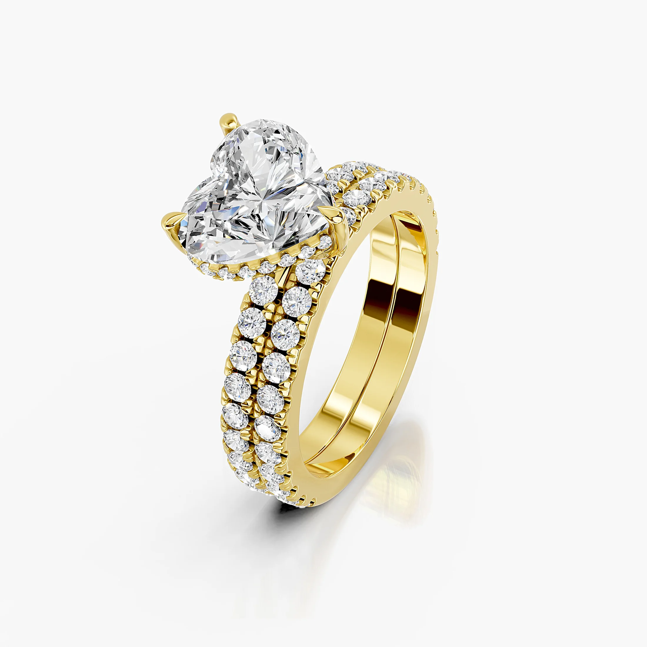 Heart-shaped engagement ring with hidden halo, round side stones, and straight coordinating diamond wedding band