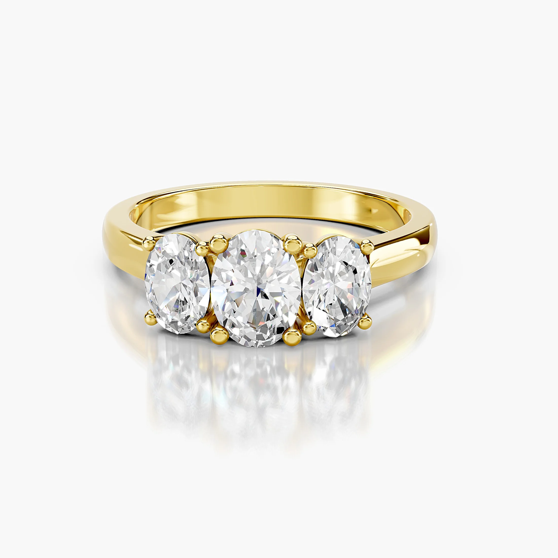 Three-stone engagement ring featuring a center oval diamond flanked by two matching oval diamonds.